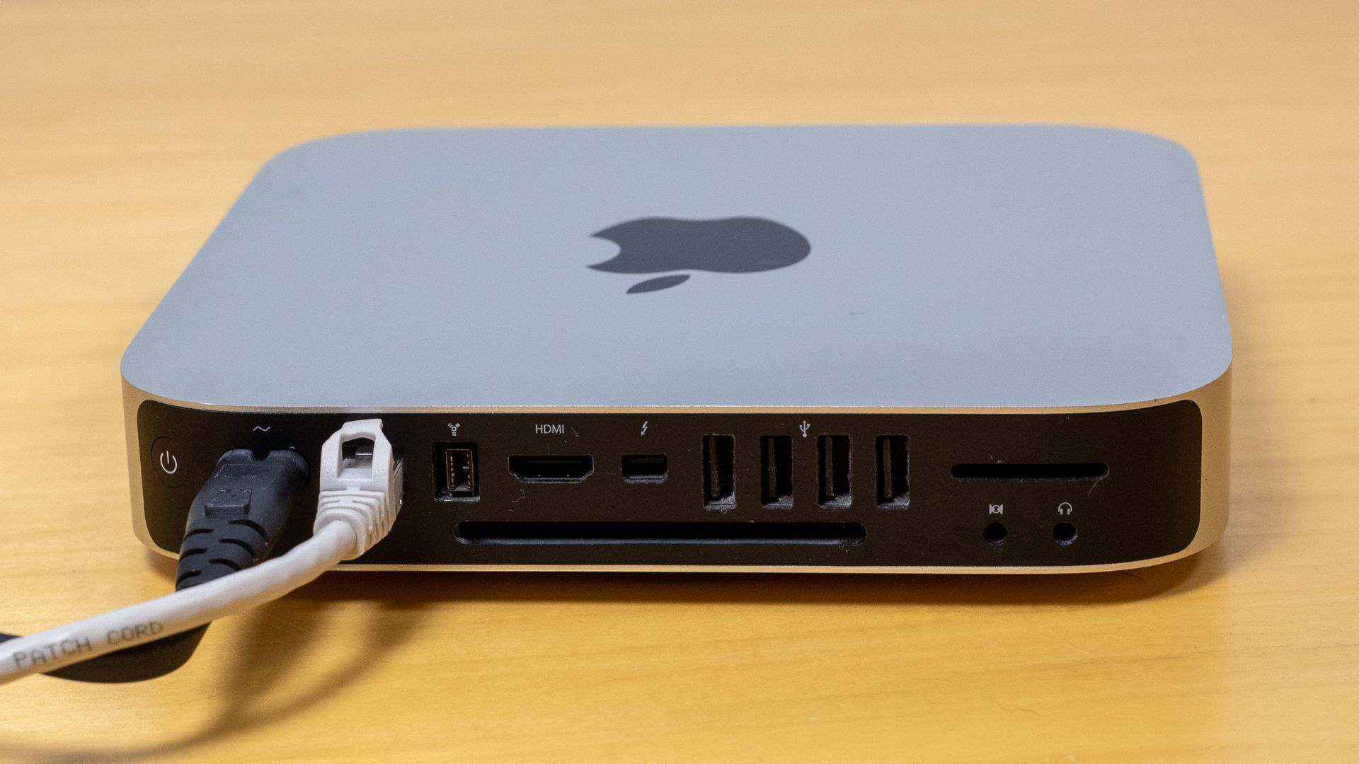 Ethernet and power cables plugged into a Mac Mini.