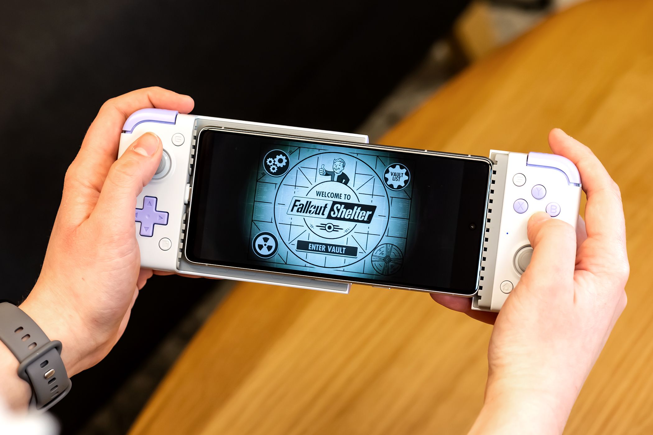 Person playing a game on the GameSir X2s.