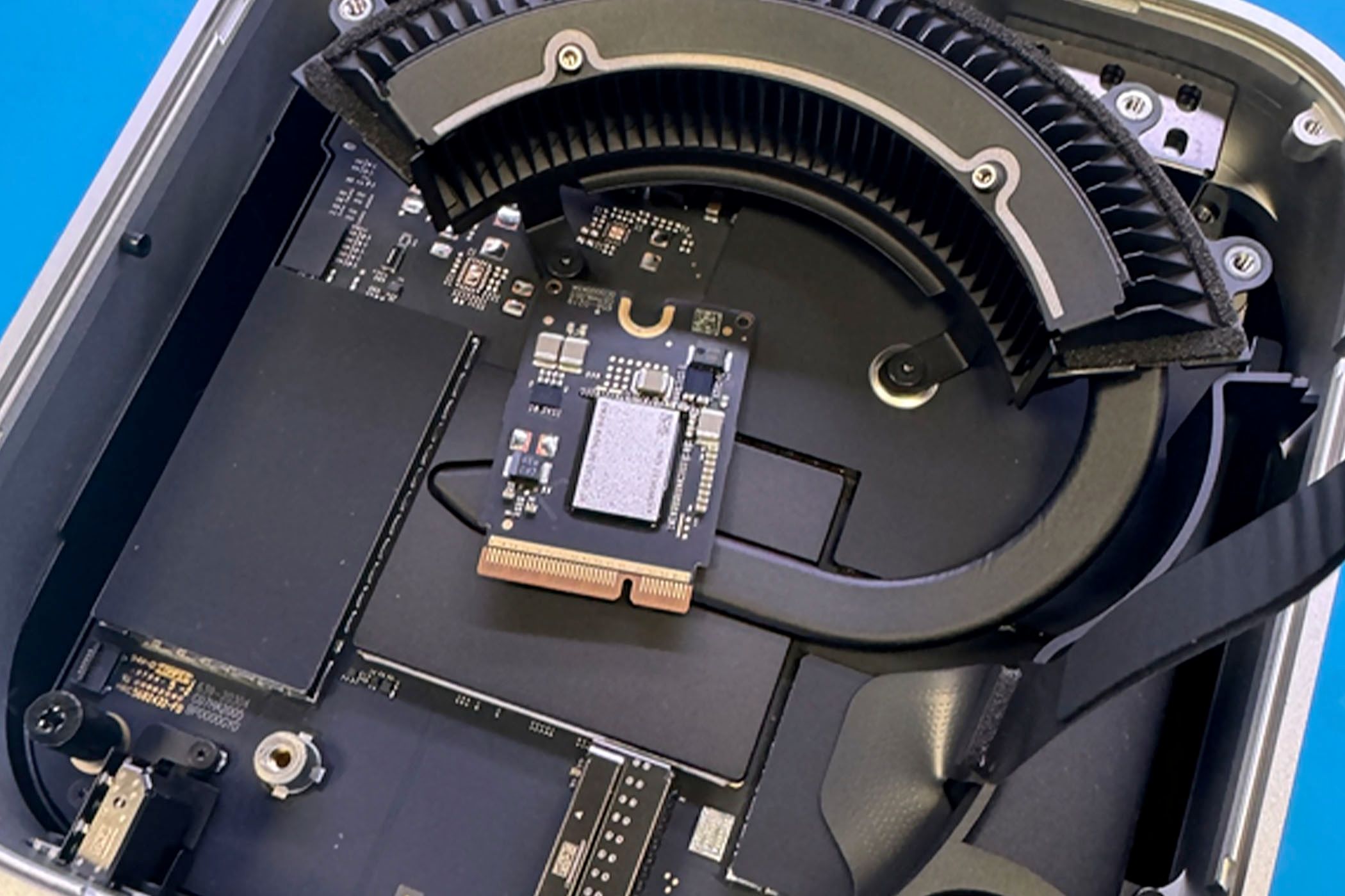 The M4 Mac Mini opened with its proprietary storage module removed.