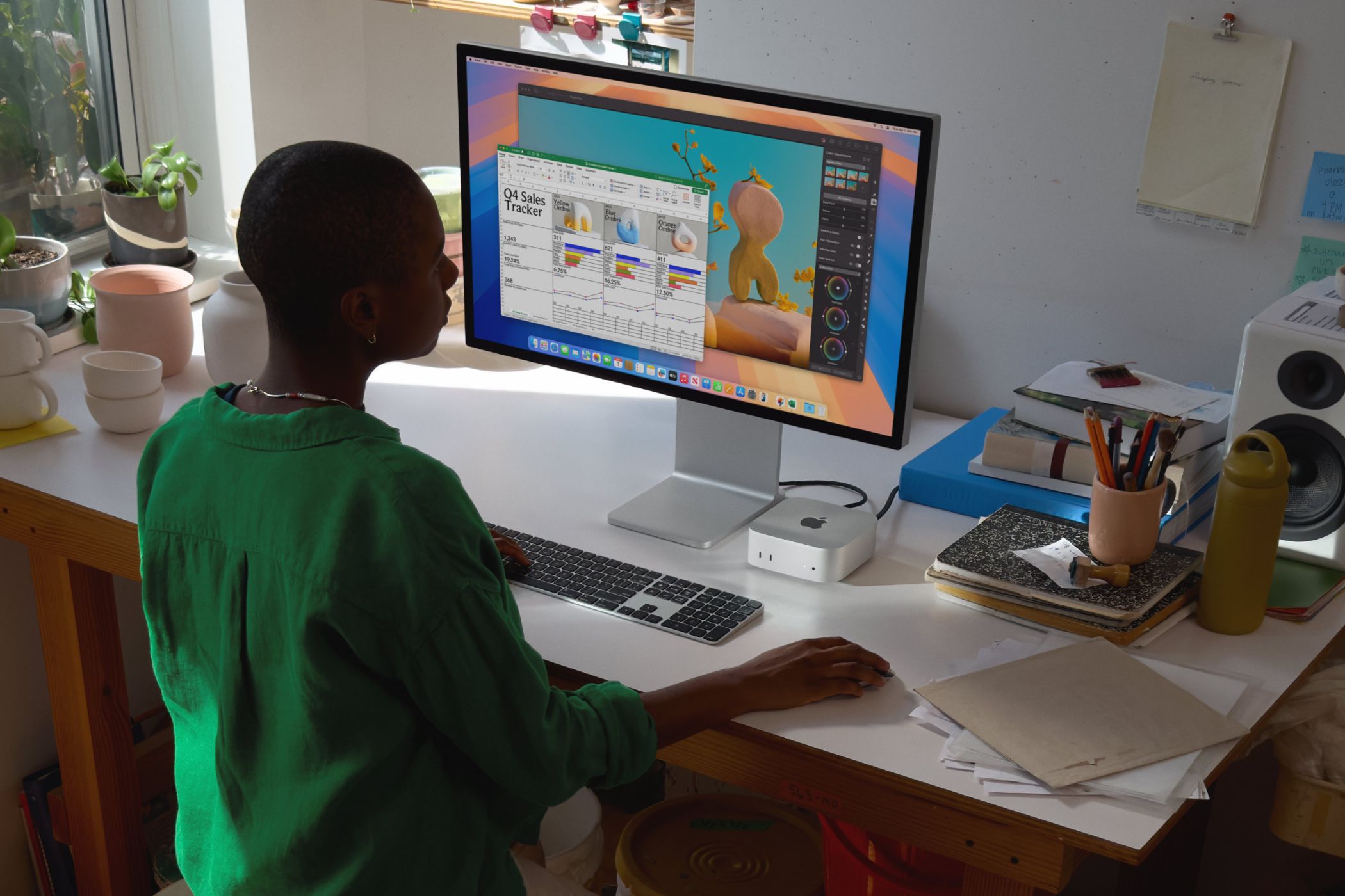 A Mac Mini on a desk with an Apple Studio Display.