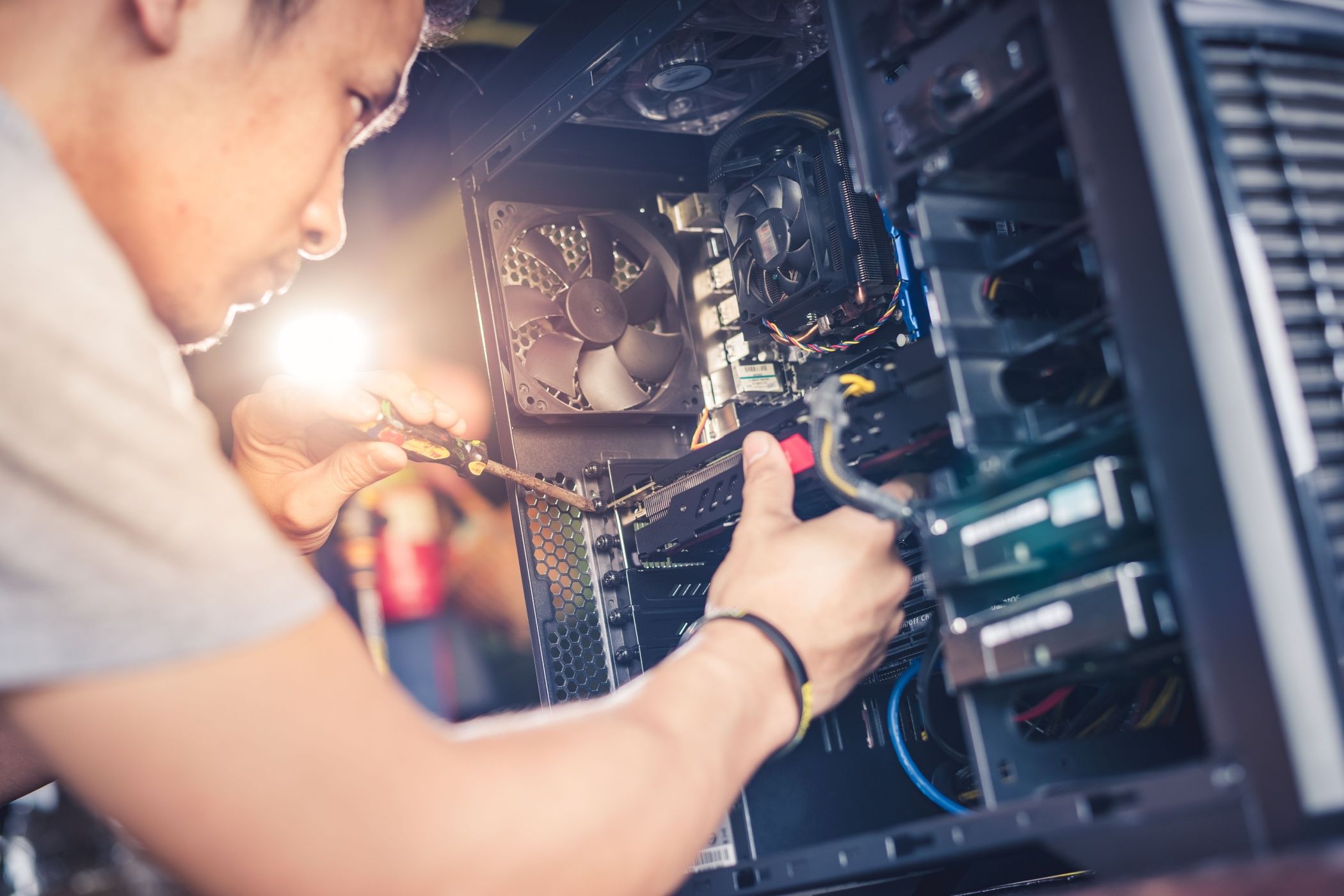 A person installing a graphics card in a computer.