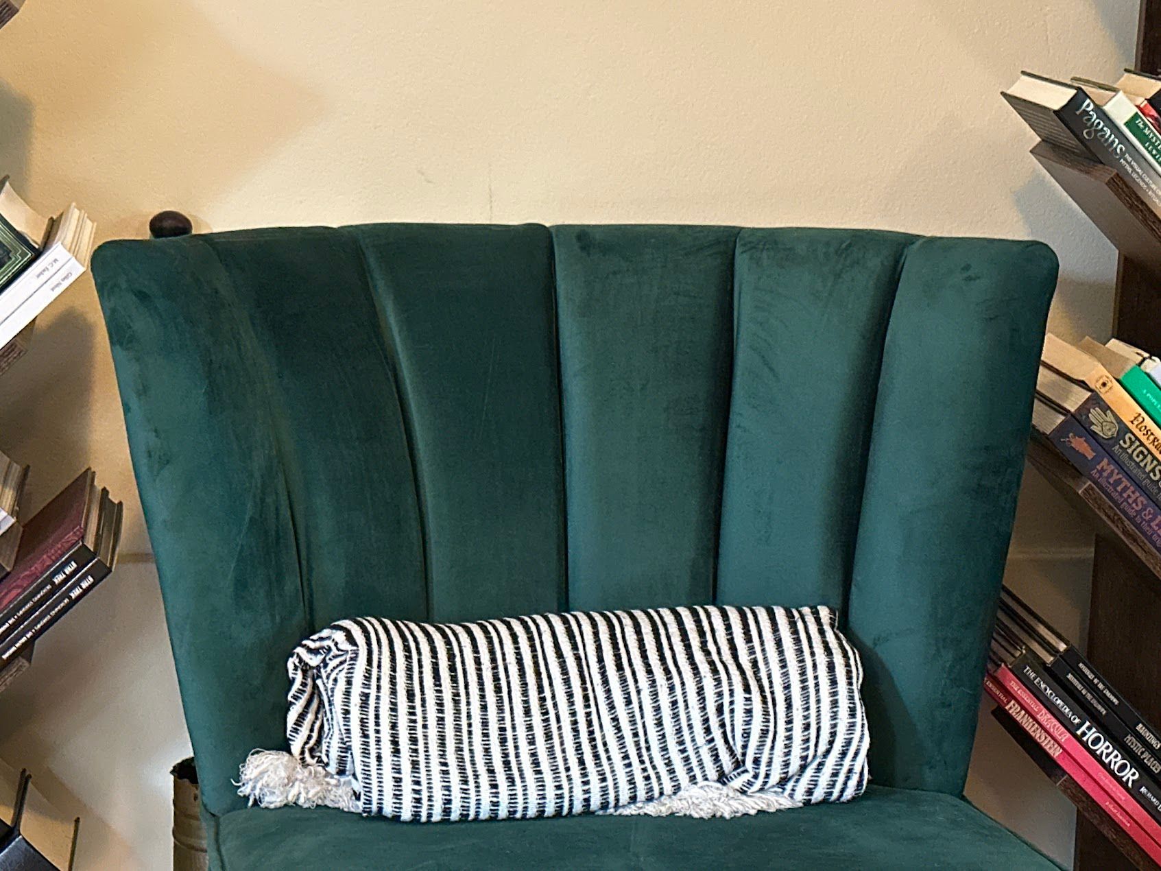 A photo of a chair and two bookshelves taken with an iPhone 14 Pro telephoto camera lens.