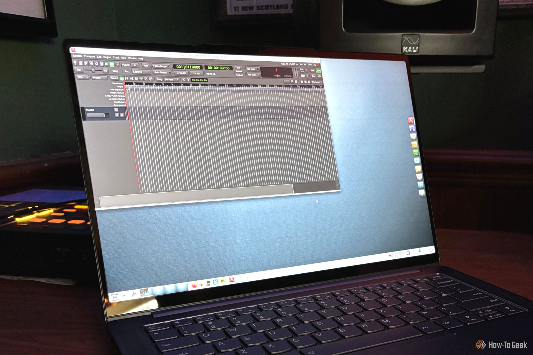 AV Linux running the Ardour DAW on a laptop in front of a speaker.