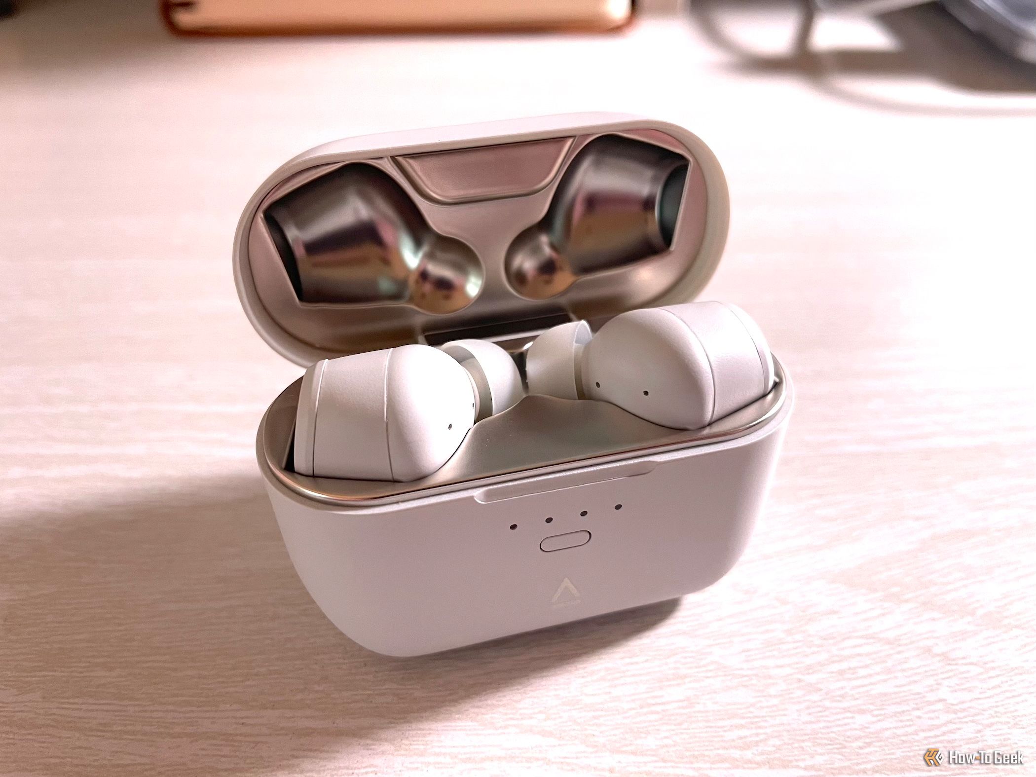 The Creative Zen Air SXFI earbuds in their charging case.