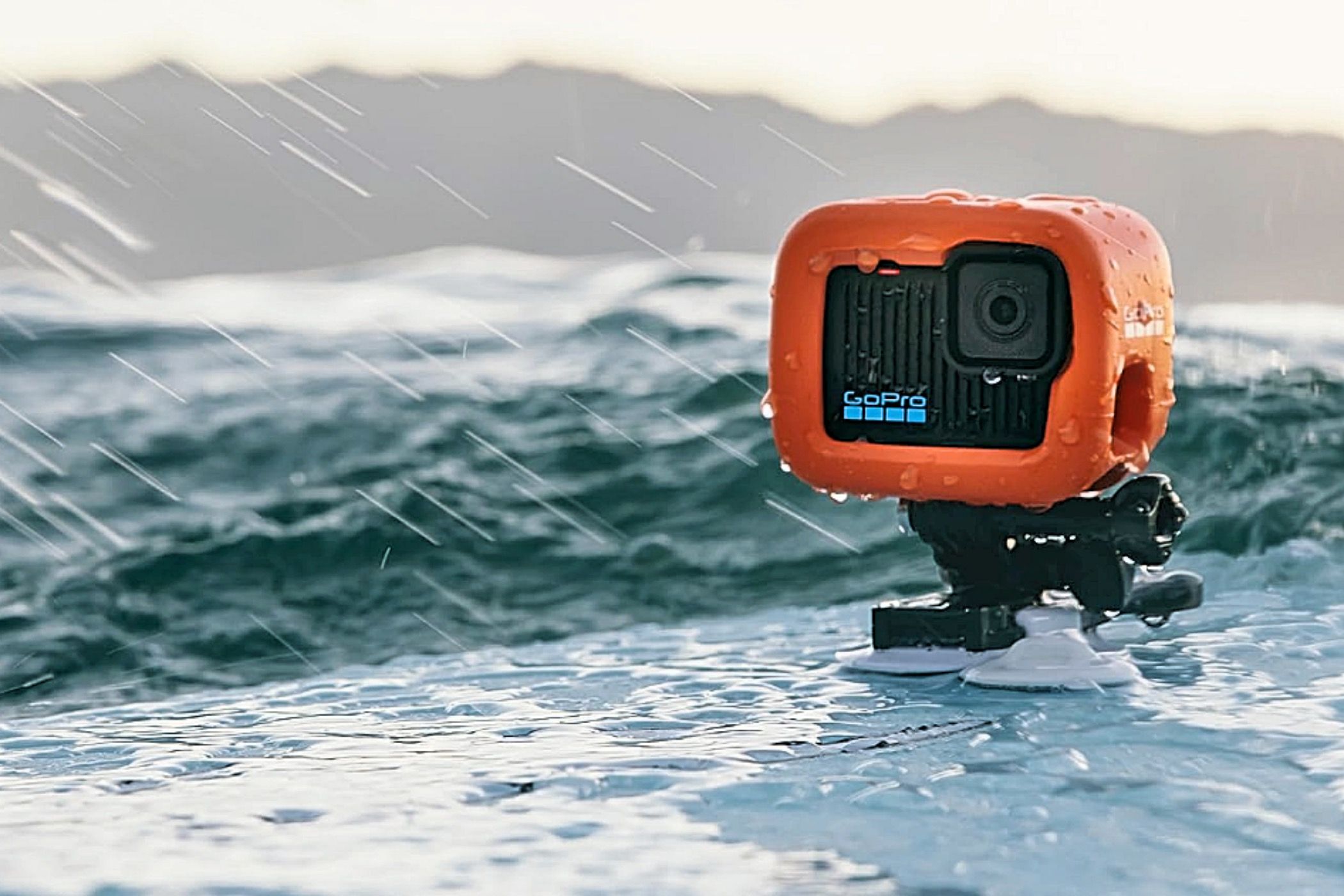 A GoPro Hero 2024 mounted on a surfboard in the rain.