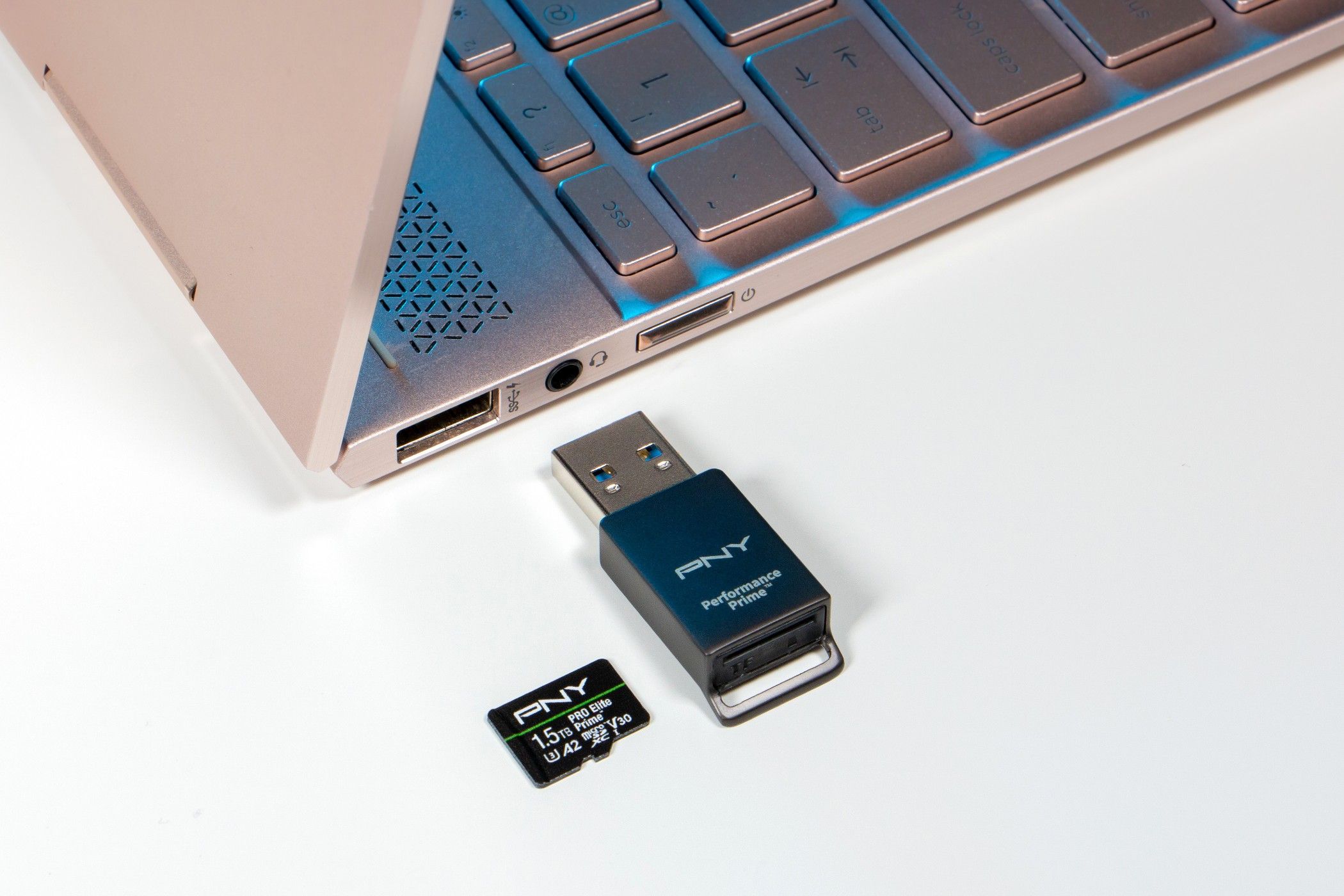 PNY PRO Elite Prime microSD cards next to laptop