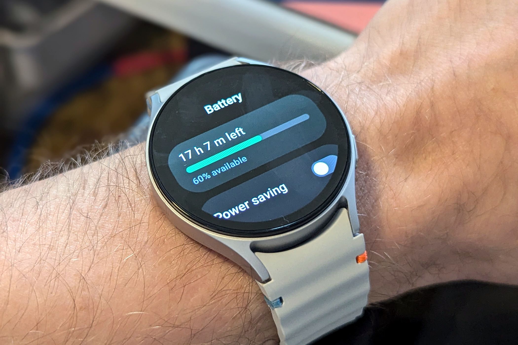 Galaxy Watch 7 on a wrist with the battery information on the screen.