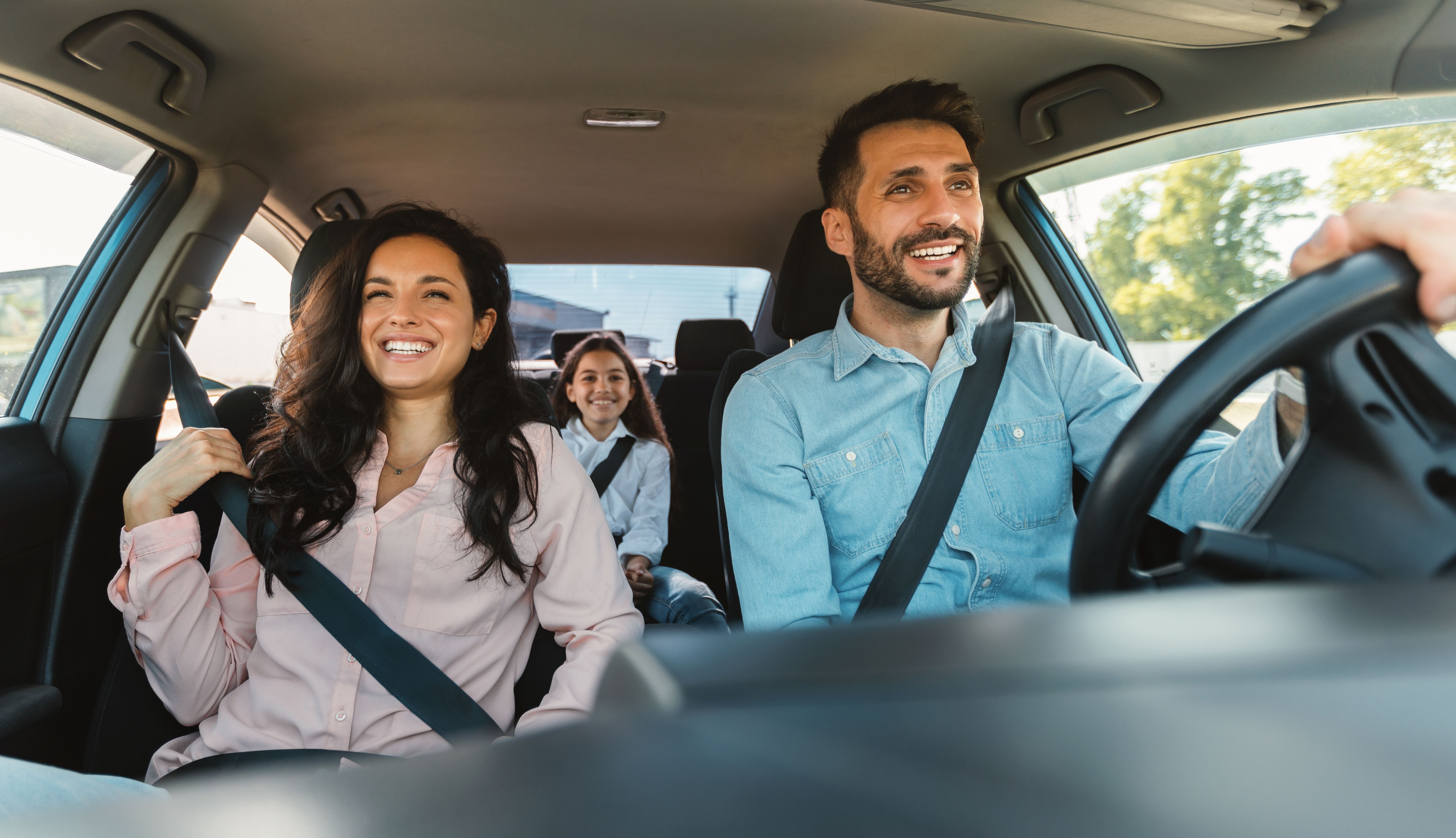 Parents and daughter enjoying road trip on weekend.