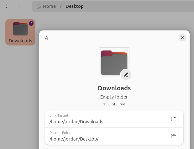 Ubuntu Files file manager showing the properties of a symbolic link in the Desktop folder linking to the Downloads folder.