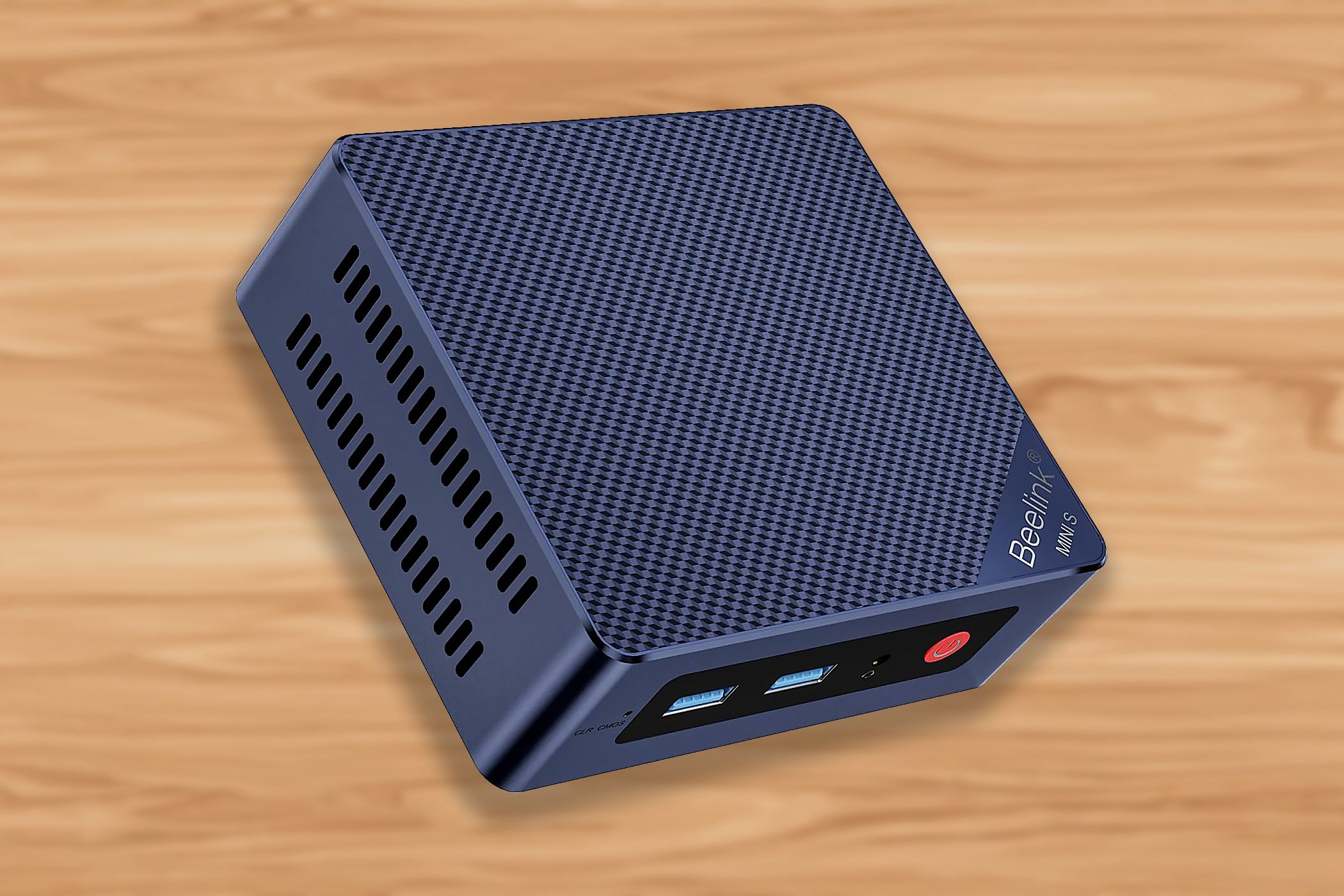 The Beelink S13 mini PC over a woodgrain background.