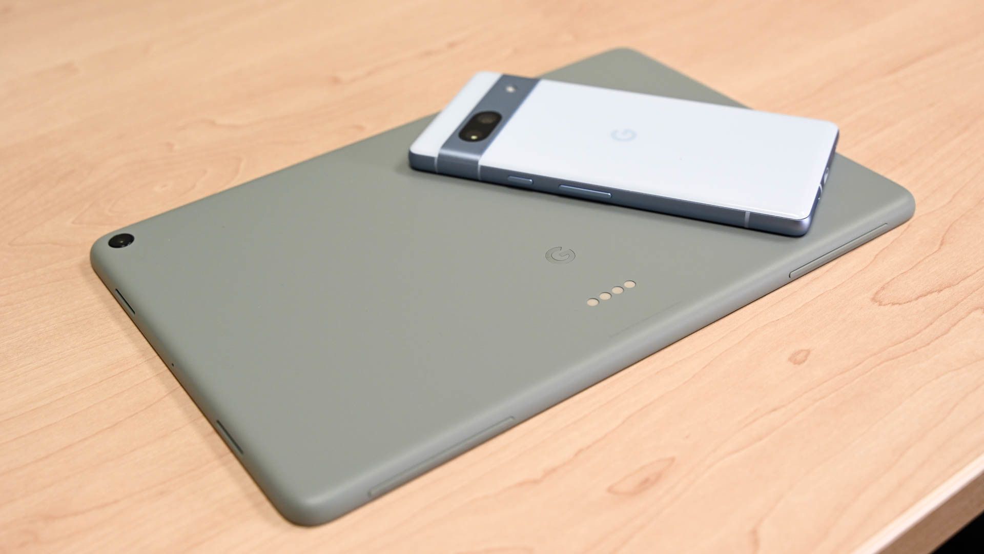 Google Pixel tablet with a Google Pixel 7a on a table.