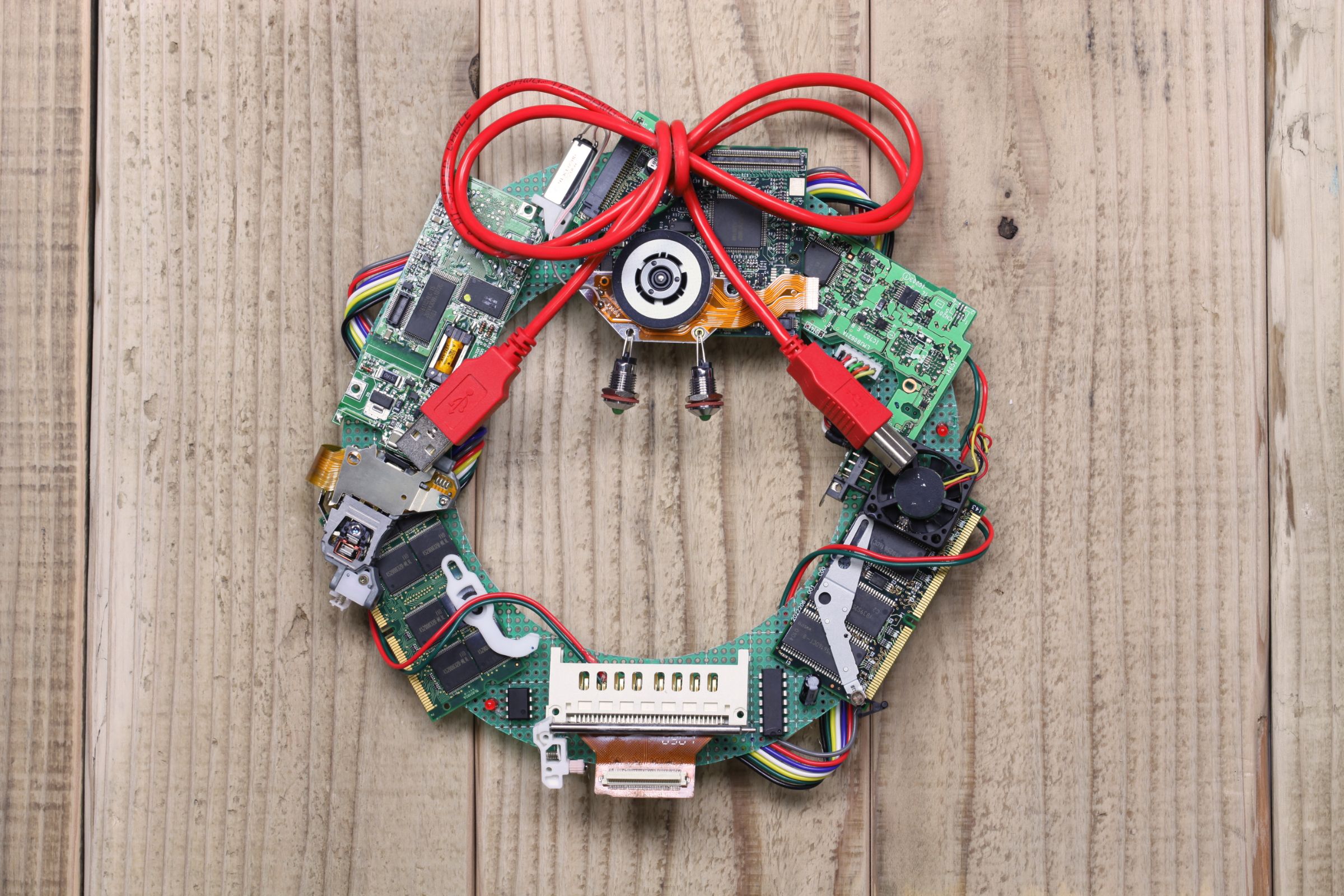 A Christmas wreath gift made from tech like USB ports, Ethernet cables, and computer chips.