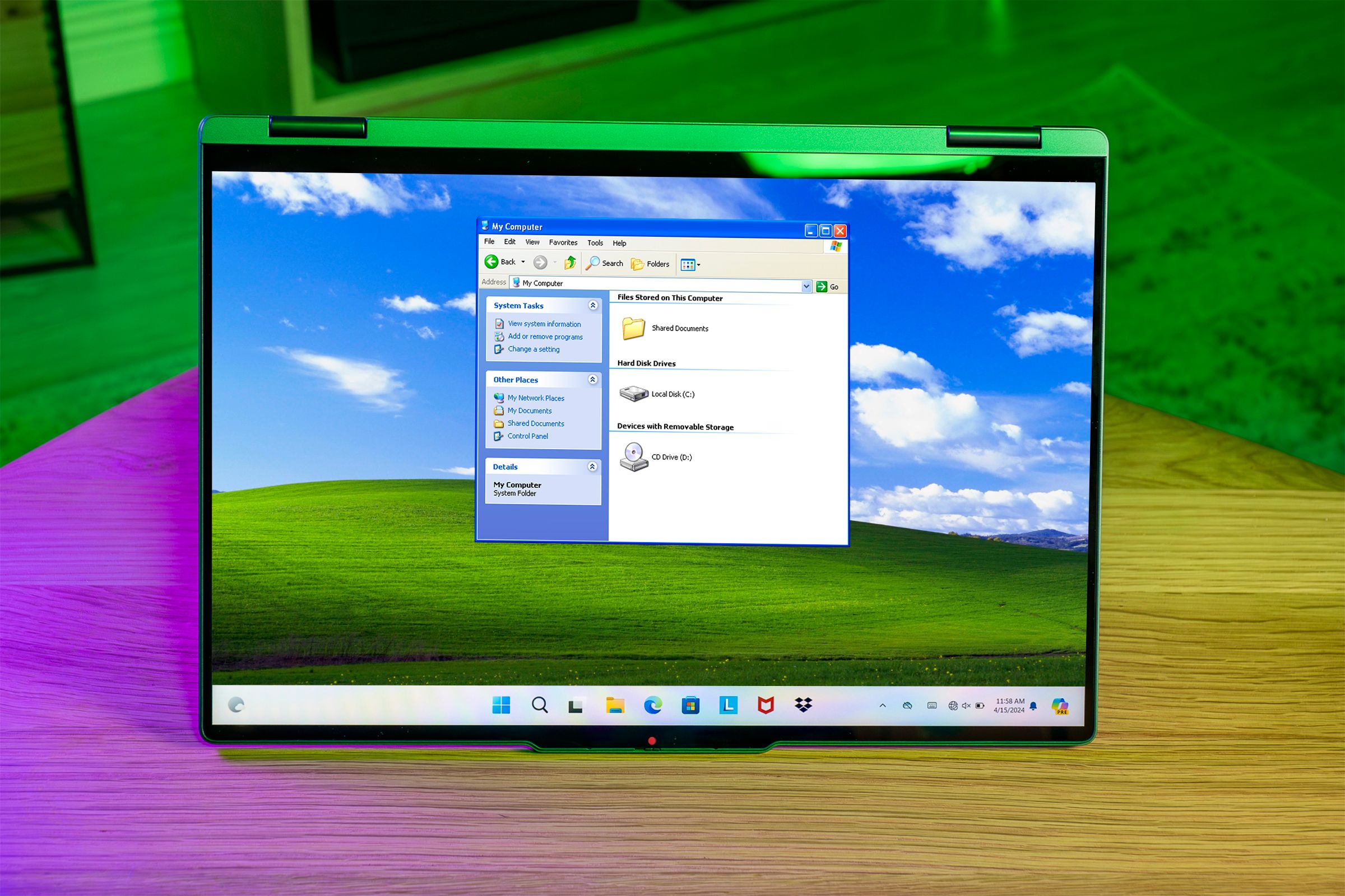 A screen with the Windows 11 Start menu and the wallpaper and File Explorer from Windows XP.