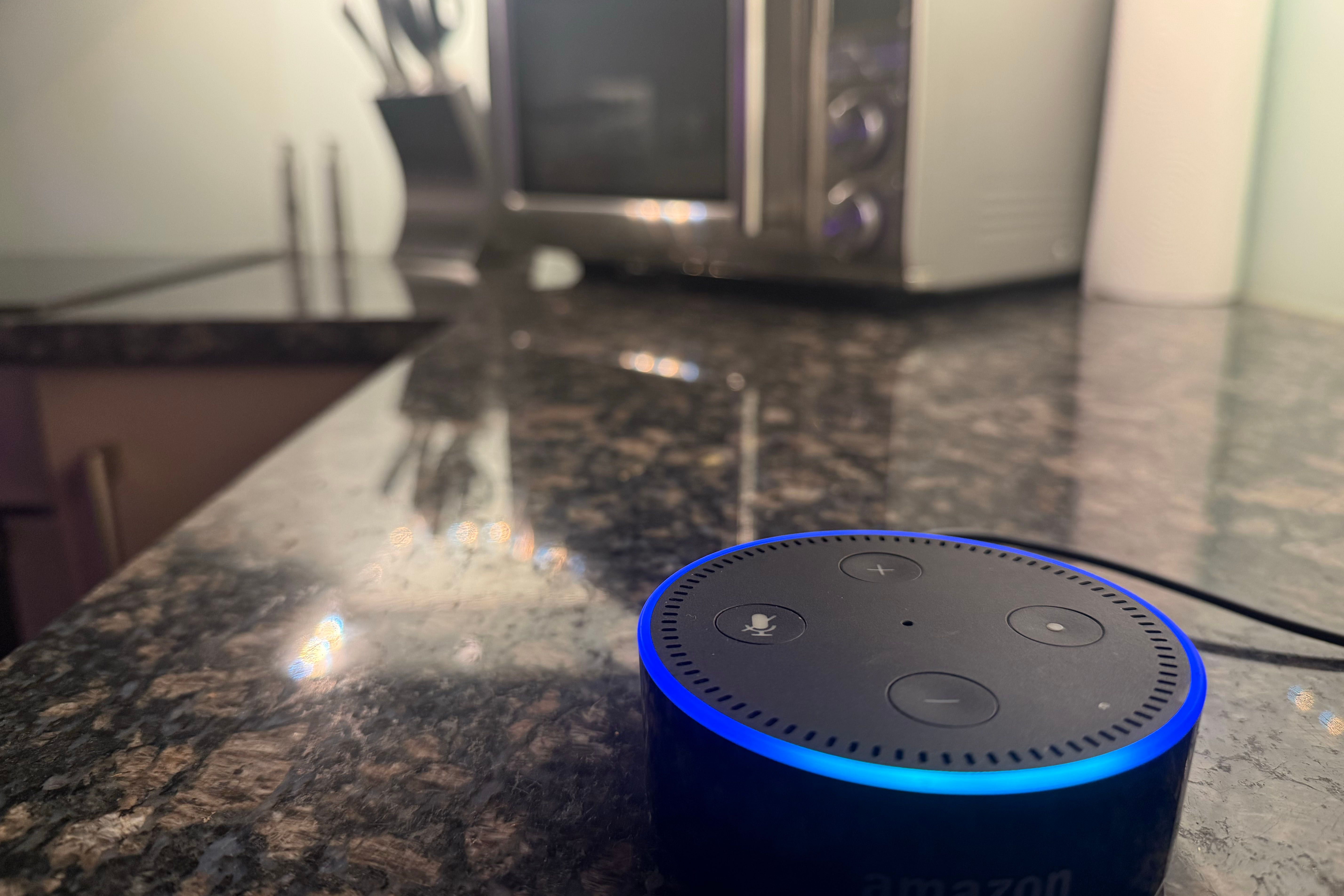 An Amazon Echo Dot speaker in a kitchen.