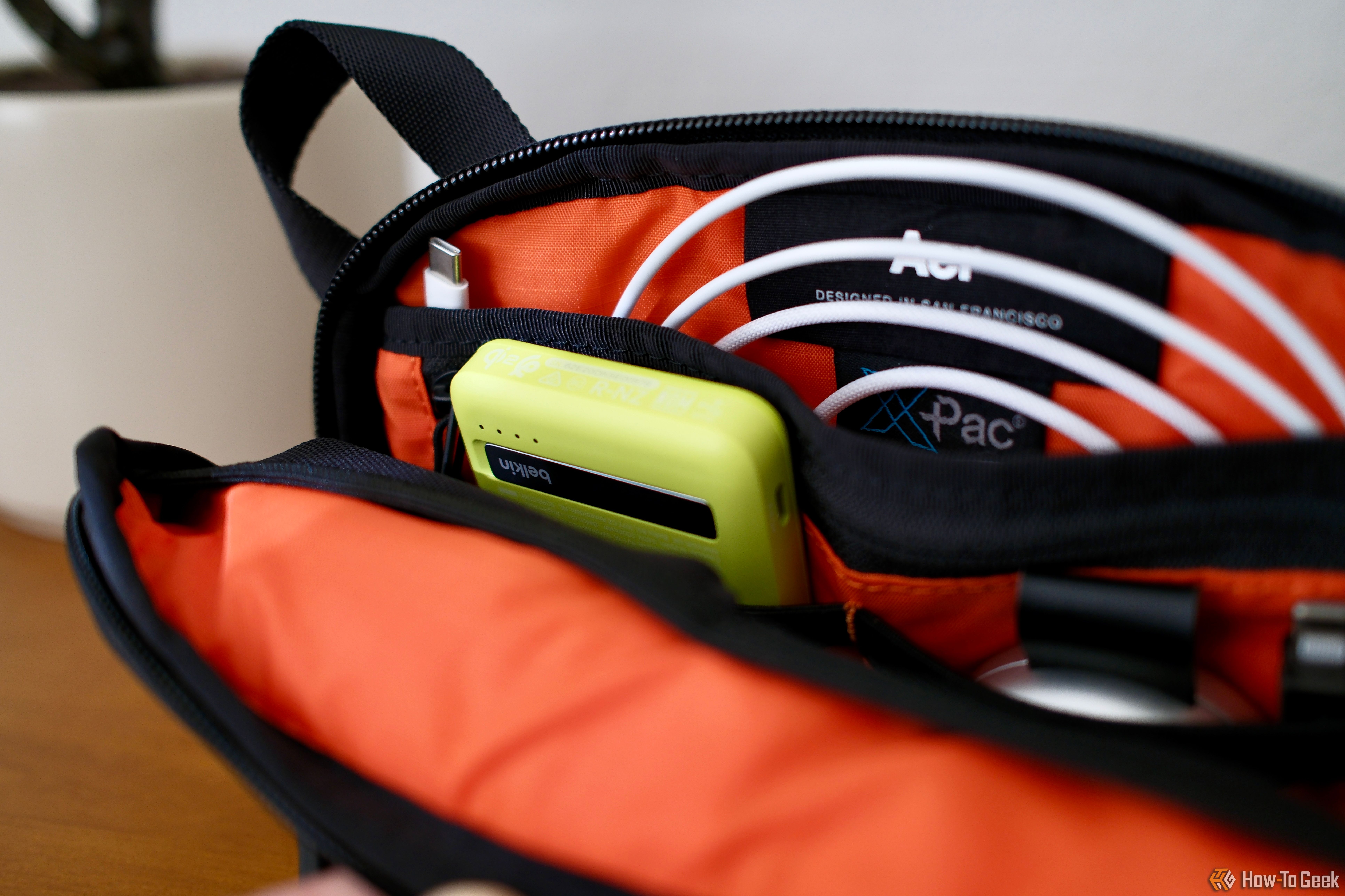 Belkin BoostCharge Pro Power Bank 5K tucked into a pocket of a bag