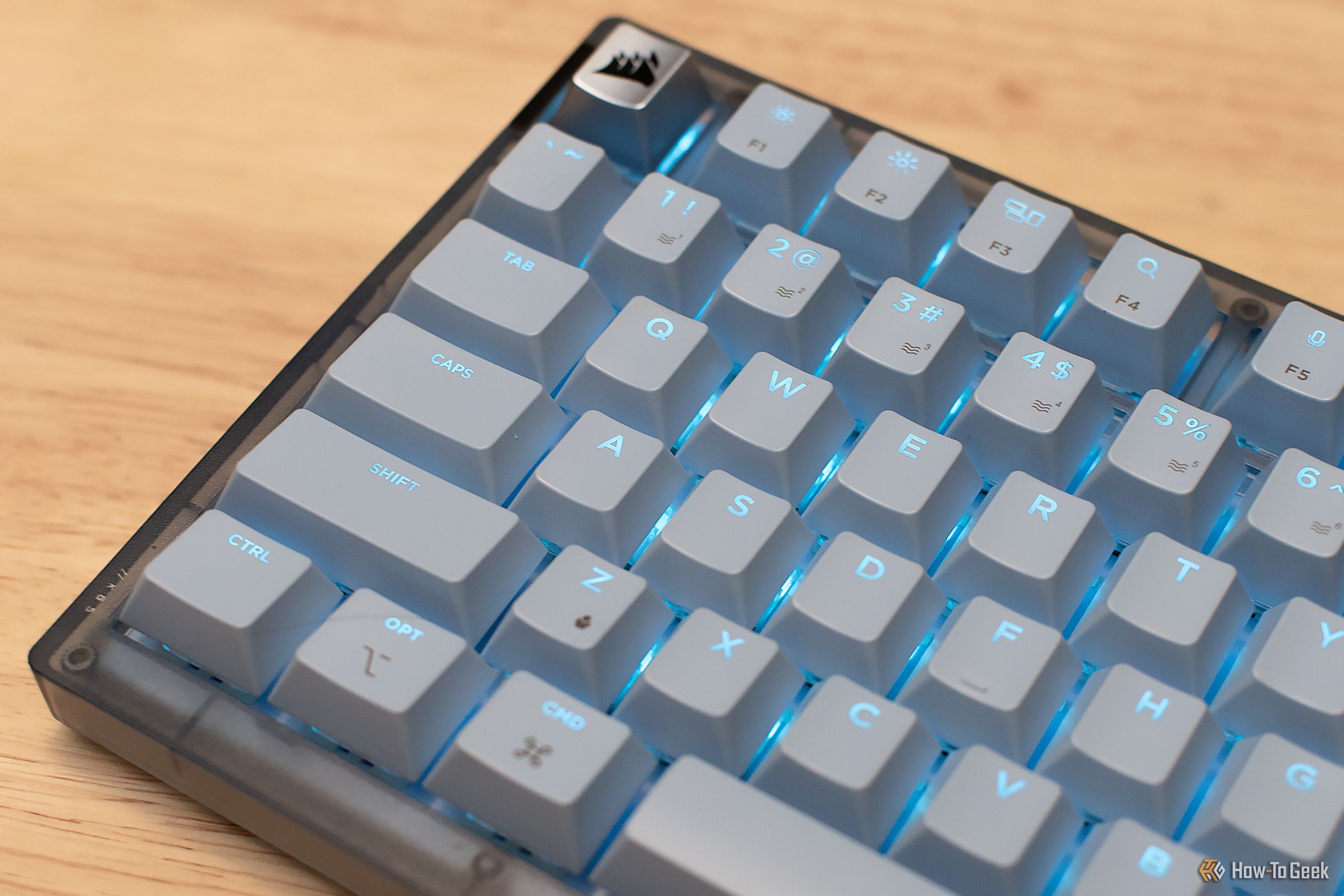 Corsair K65 Apple Edition mechanical Mac keyboard with blue RGB lighting.