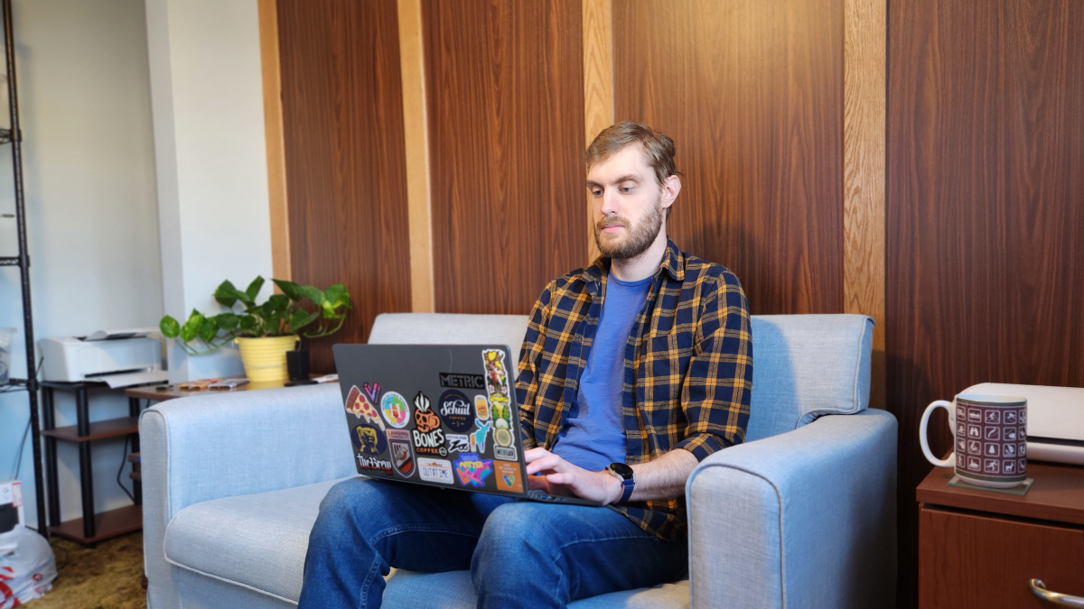 Person on couch with laptop.