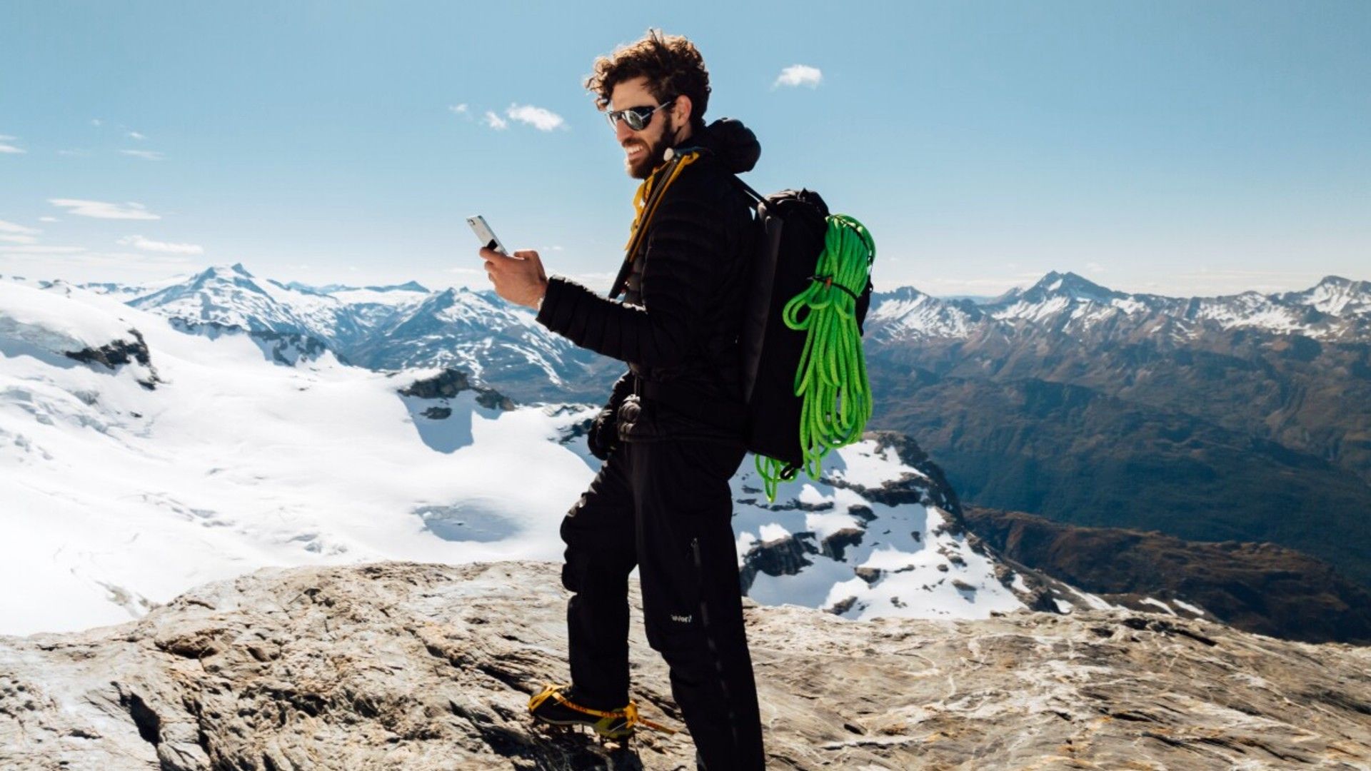 One NZ Satellite Service Starlink man on mountain using phone.