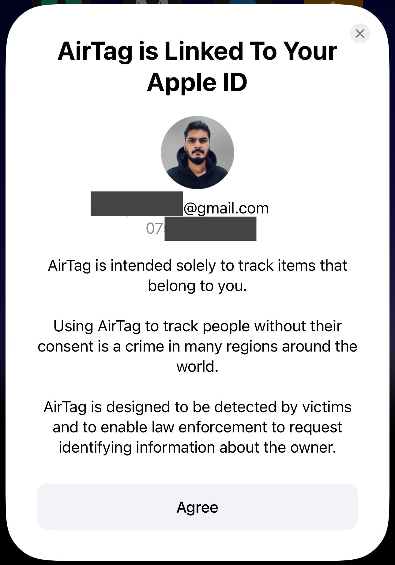 Pop-up card showing Apple ID and phone number that will be linked to the paired AirTag.