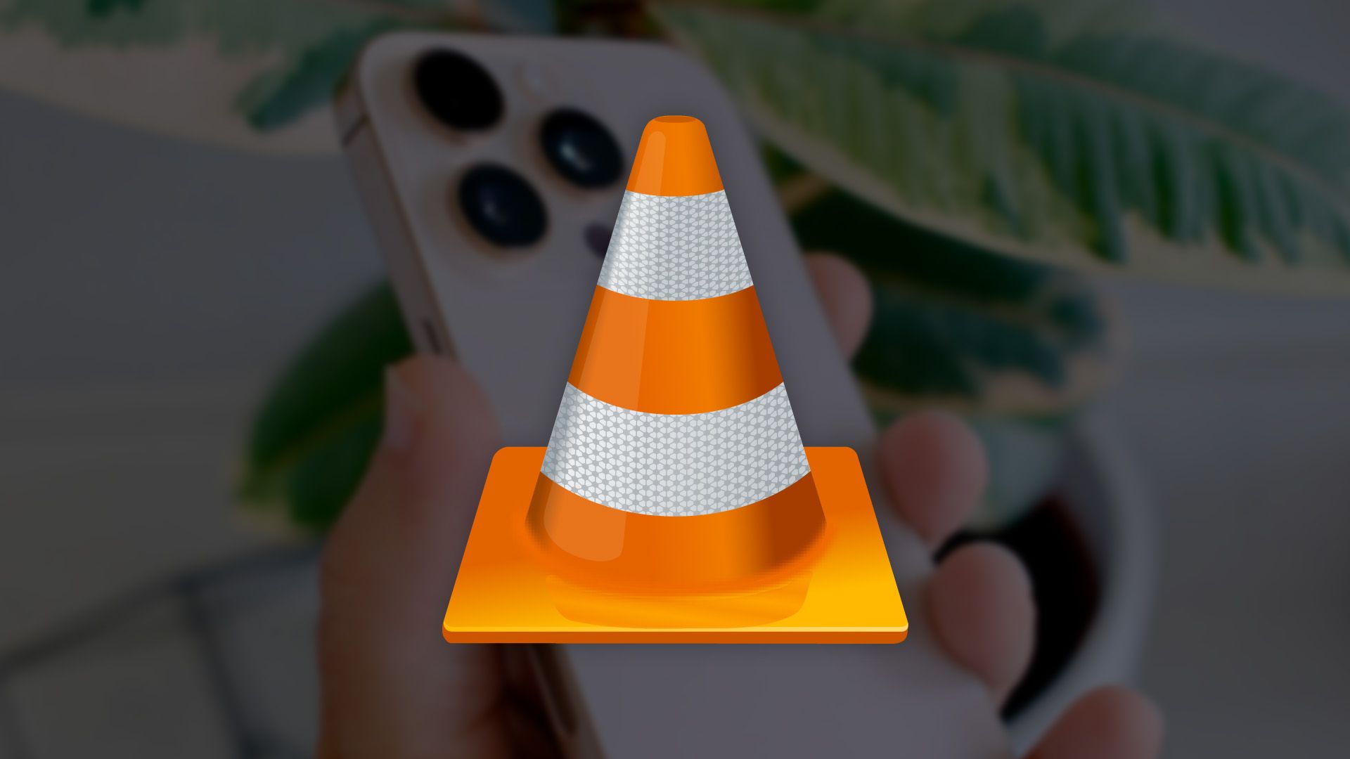 VLC logo in front of an iPhone.