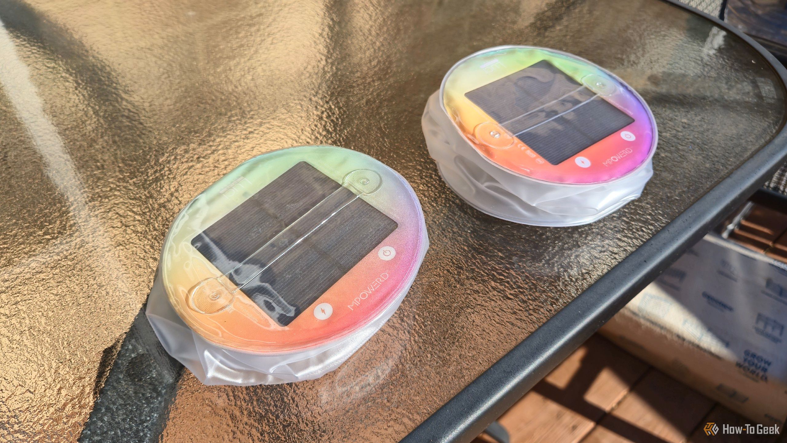 Two Luci Color solar lights, charging outdoors.