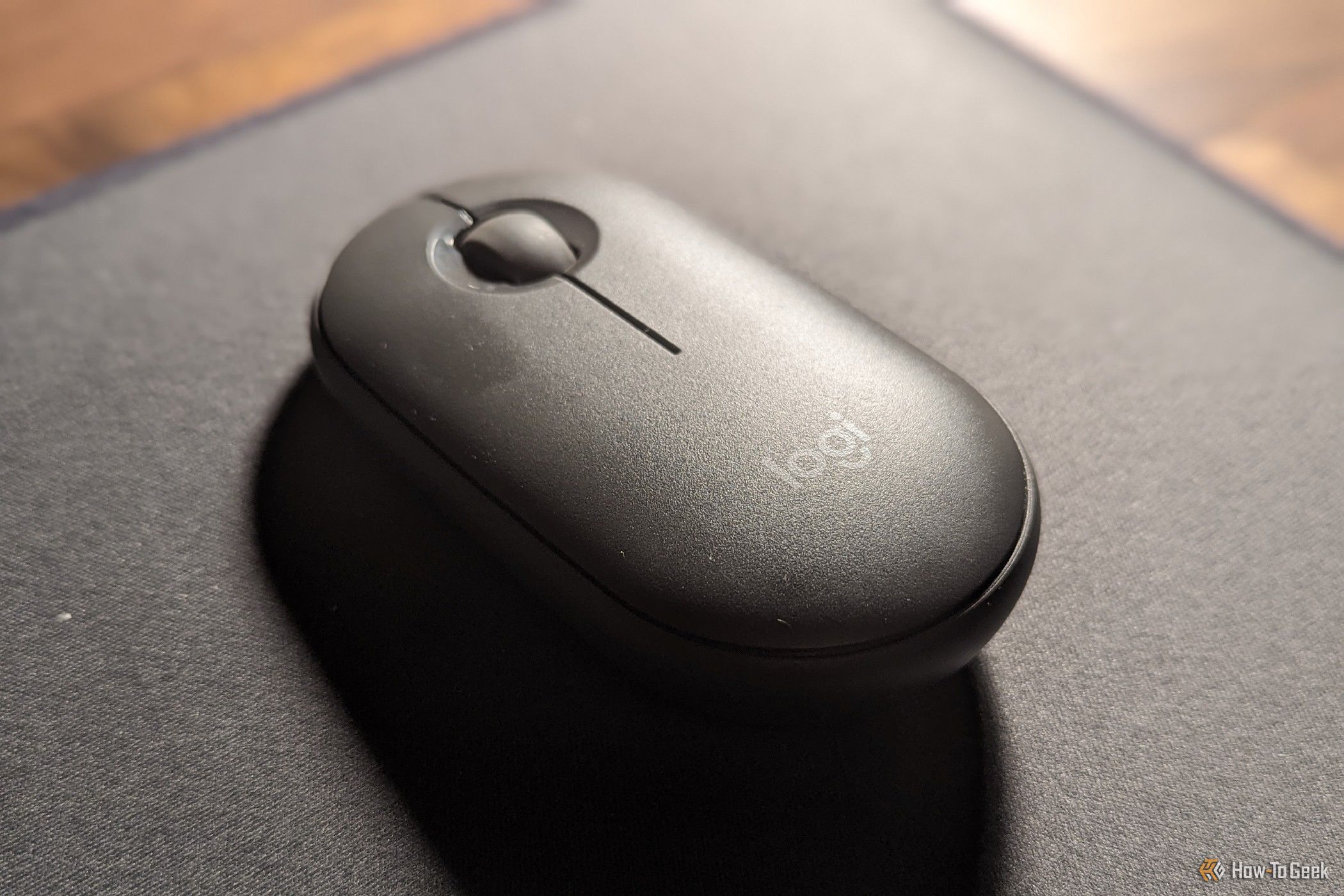 The Logitech Pebble Bluetooth mouse on a mouse pad.