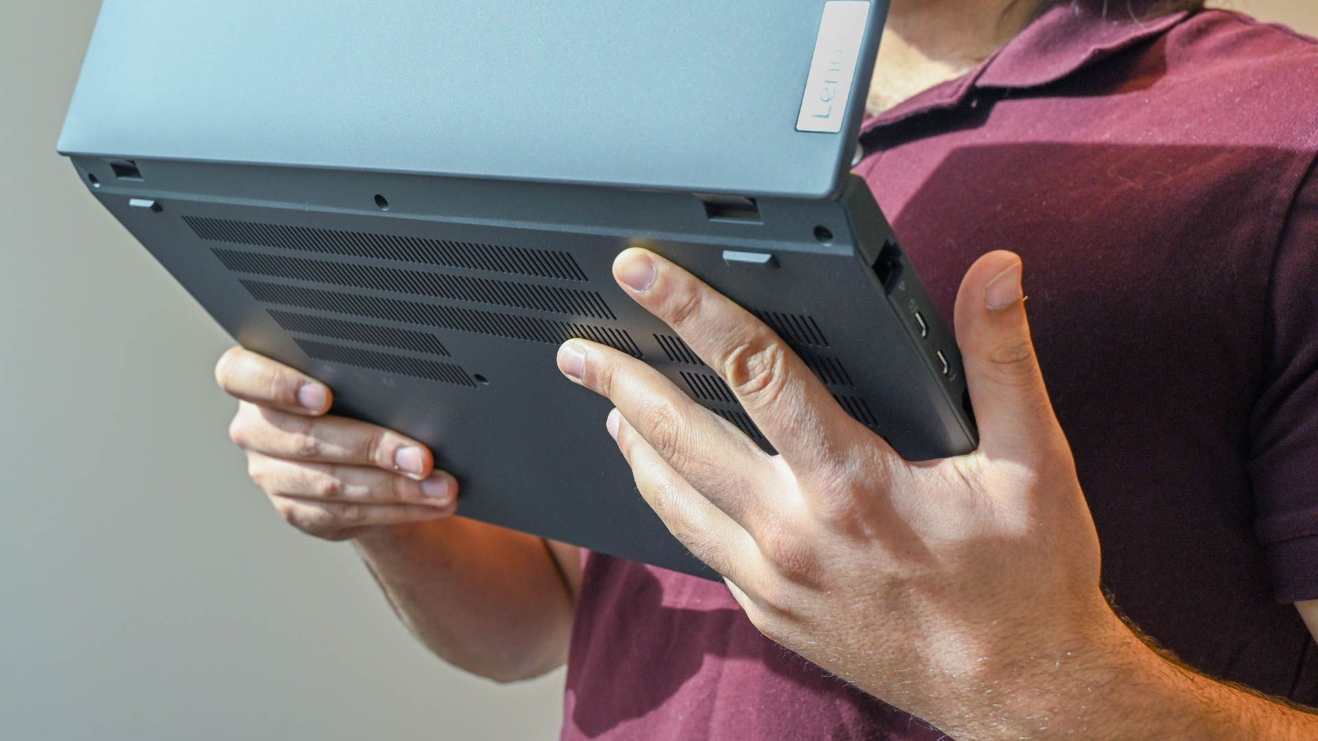 A person holding the Lenovo ThinkPad T16 Gen 1 to show the vents