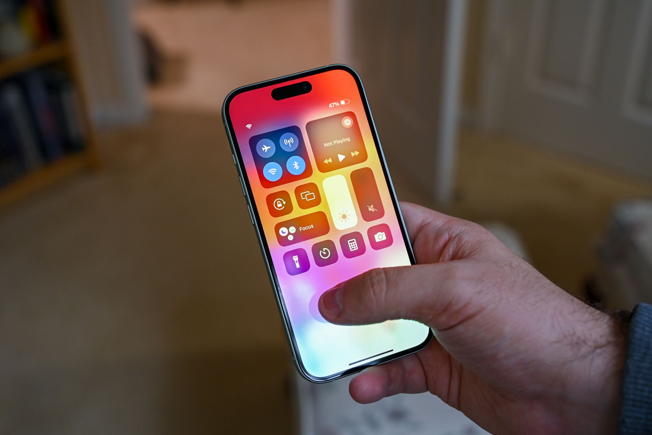 Person viewing the iPhone 15 with the control center open.