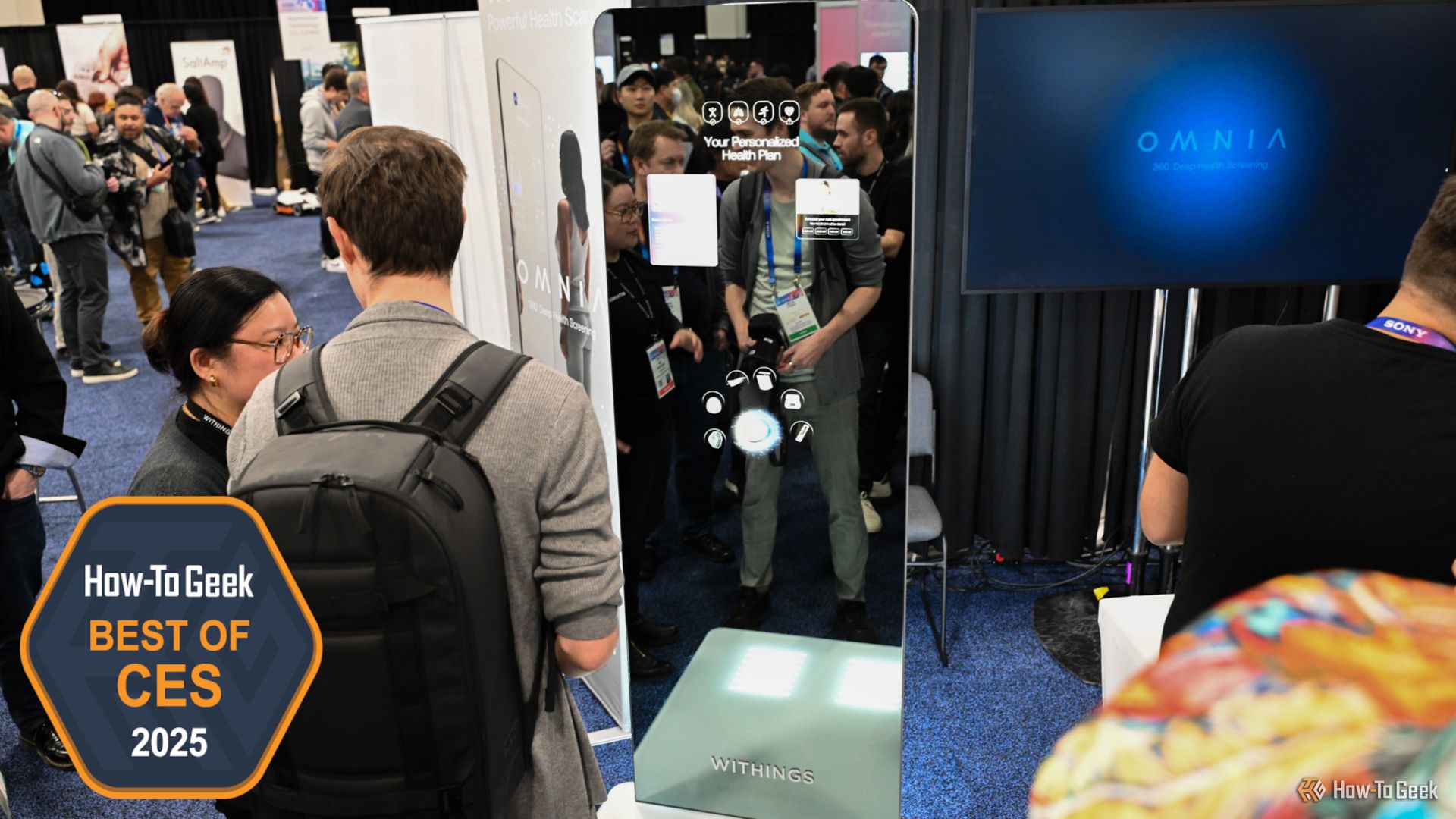 People looking at the Withings OMNIA Health Screening Mirror concept at CES.