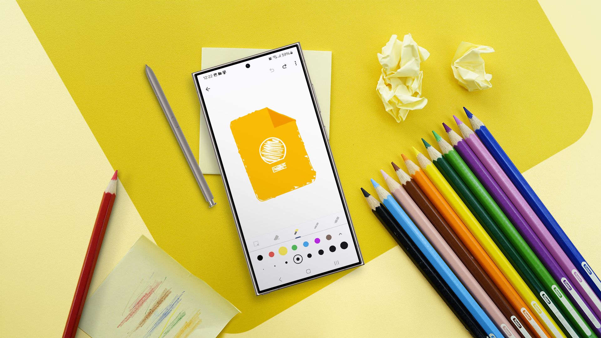 A desk with some colorful pencils and a phone in the center displaying a Google Keep sketch.