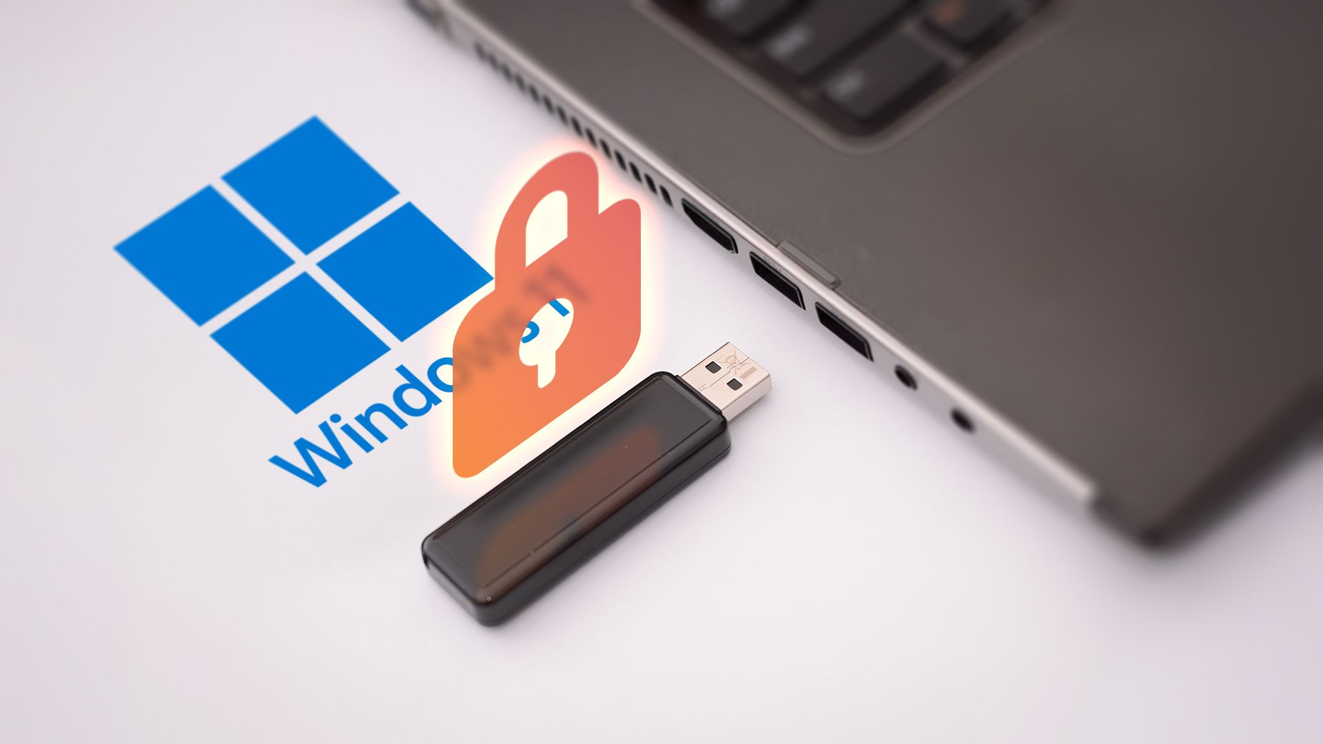 A laptop with the Windows 11 logo next to it, a USB flash drive, and a padlock above it.