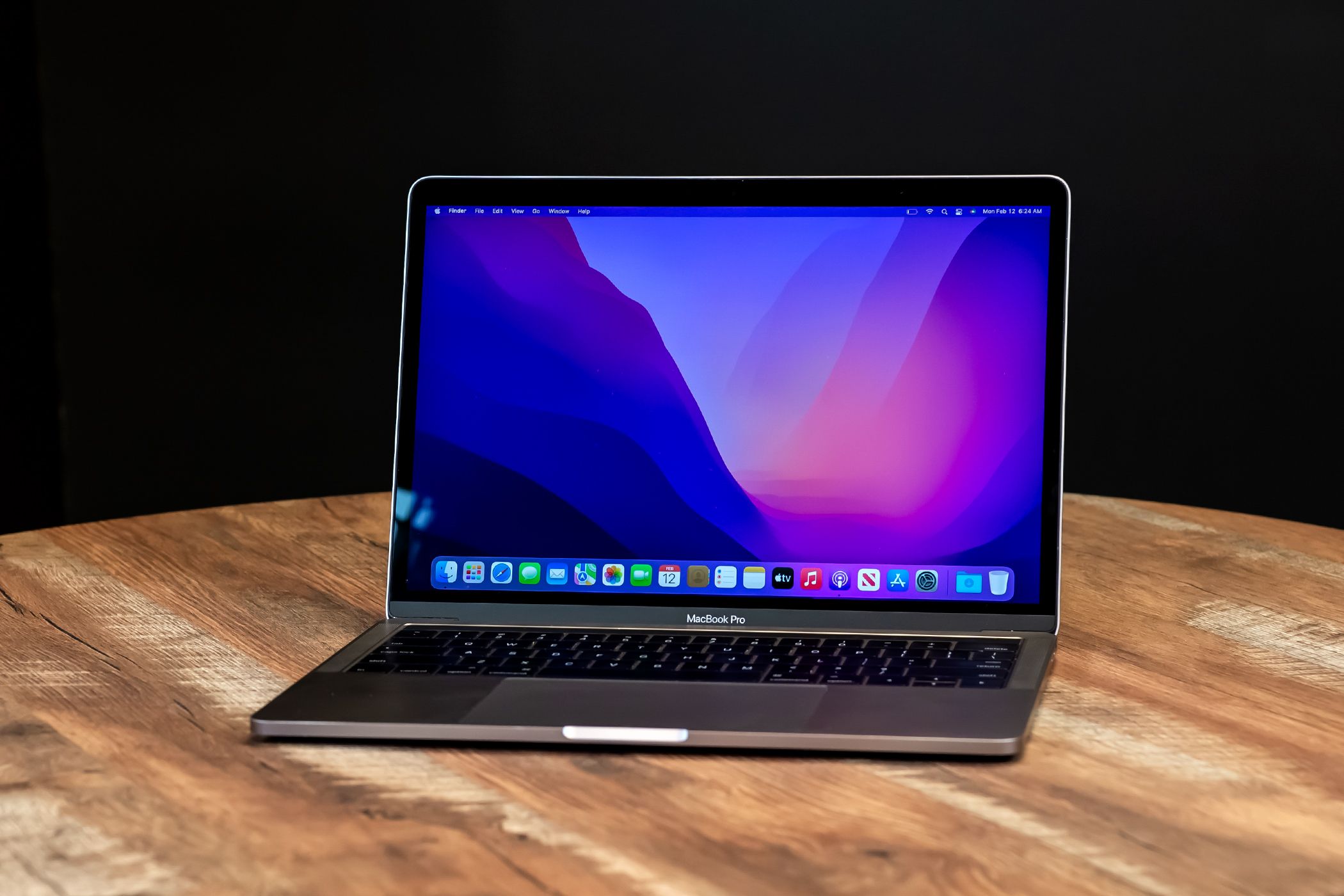 A MacBook Pro on a wooden desk.