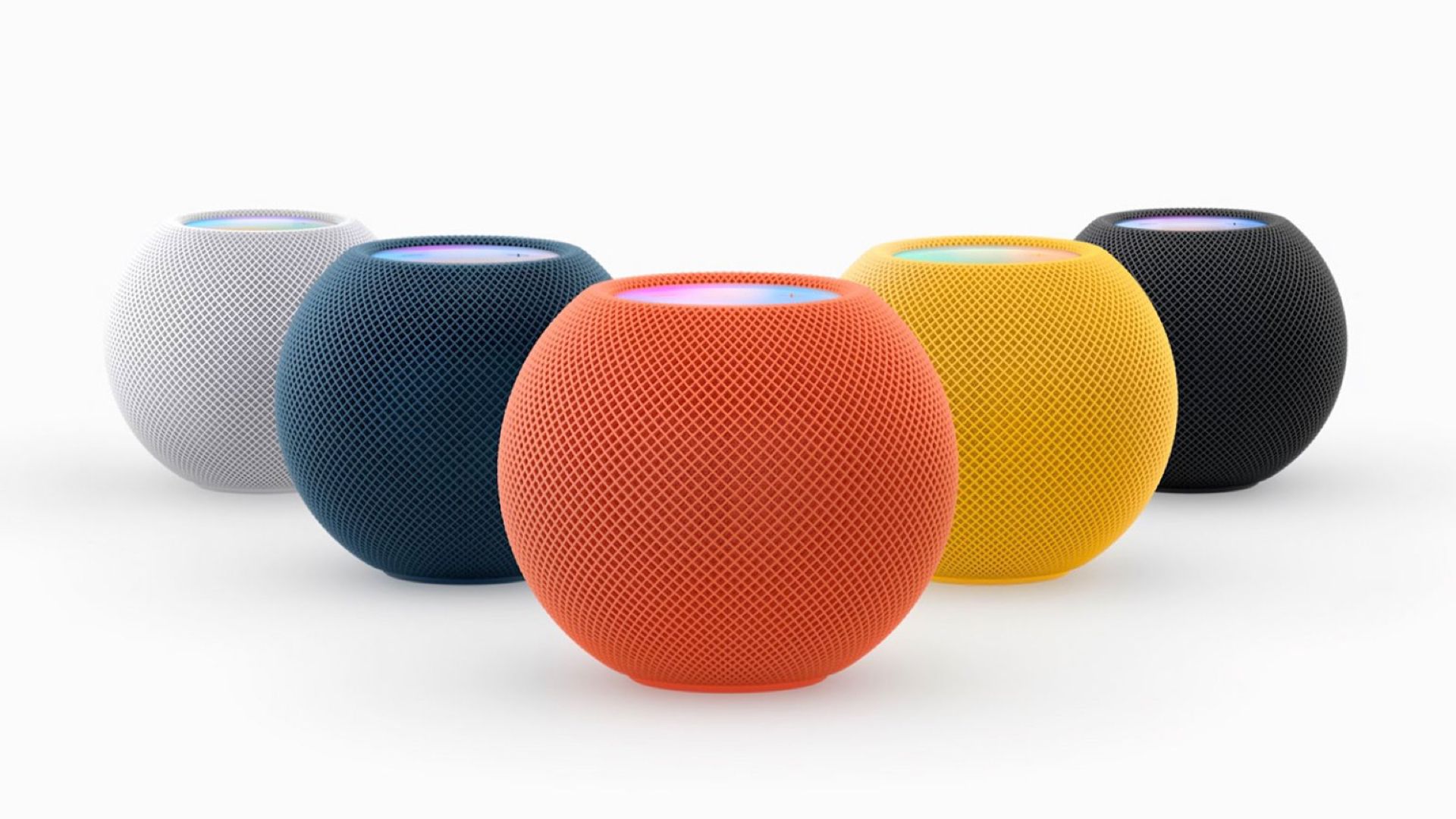 A collection of Apple HomePod mini speakers in different colors.