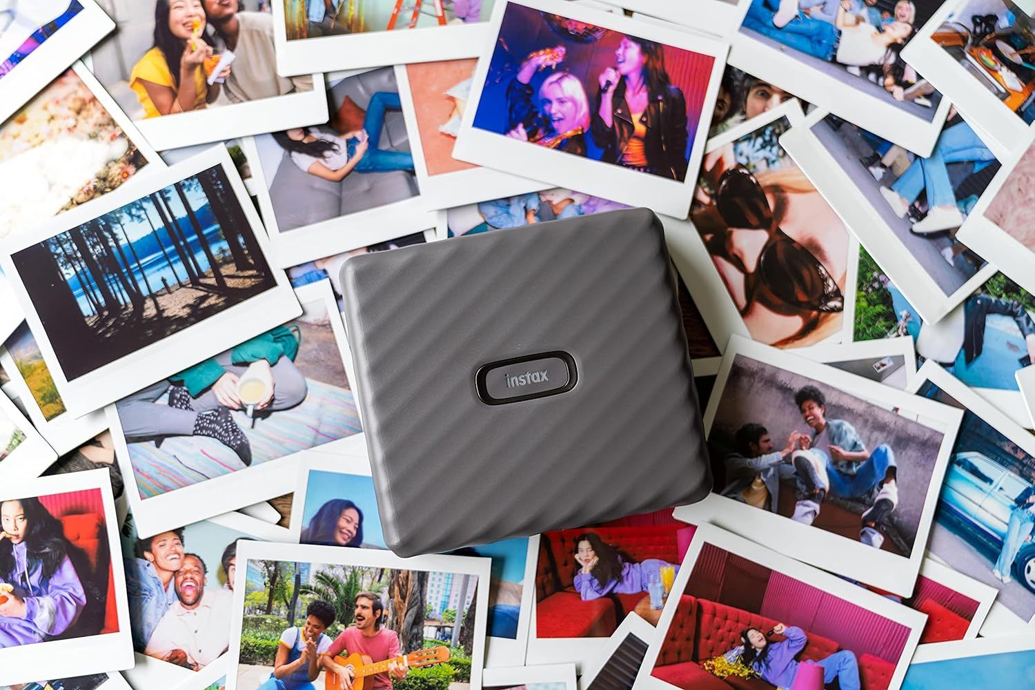 fujifilm instax link wide printer on a stack of photos