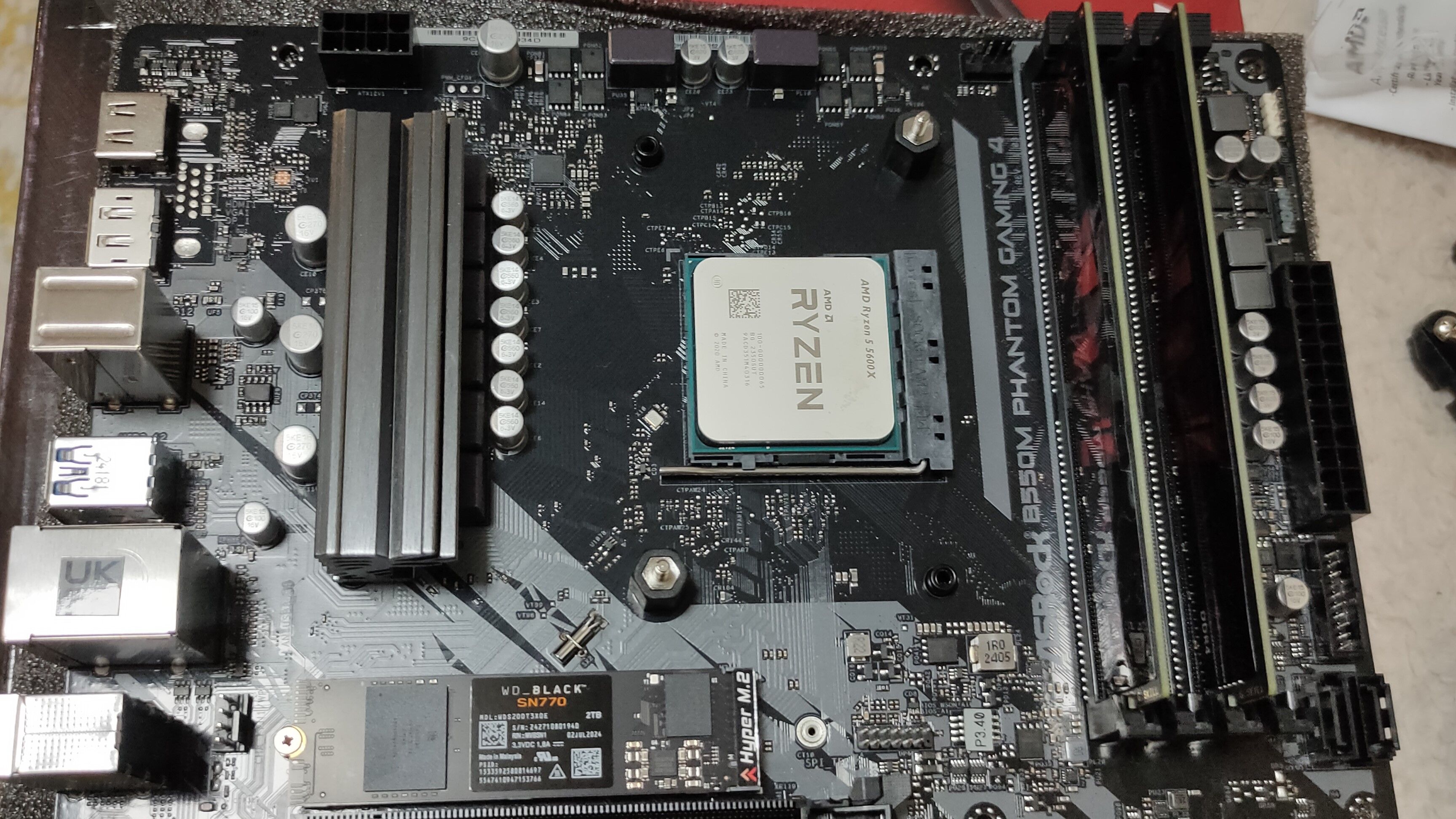 A Ryzen 5 5600X CPU inside a B550M motherboard with some DDR4 RAM and an NVMe SSD.