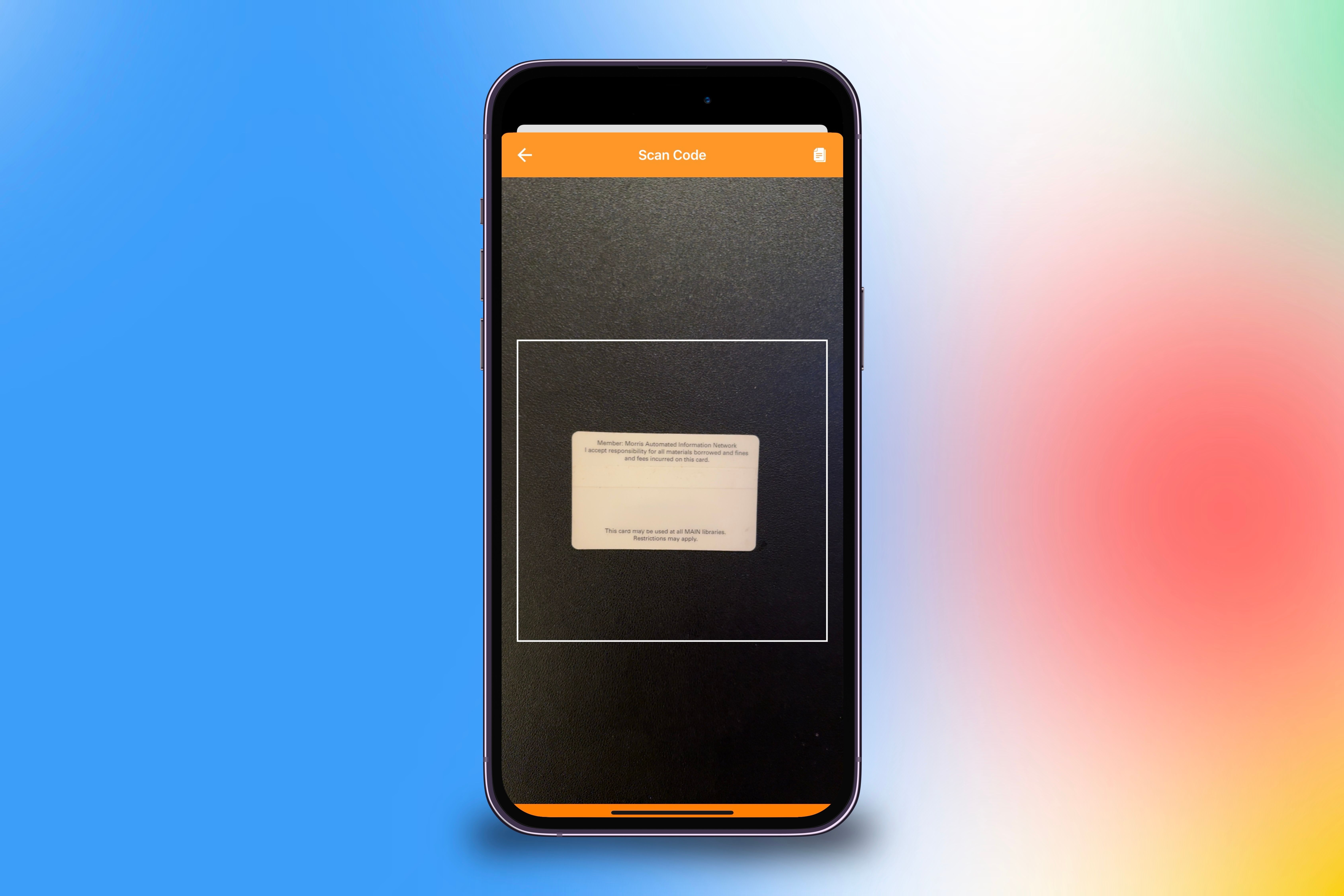 Scanning the barcode message of a physical library card into the Pass2U app to digitalize it on an iPhone in front of a colorful background.