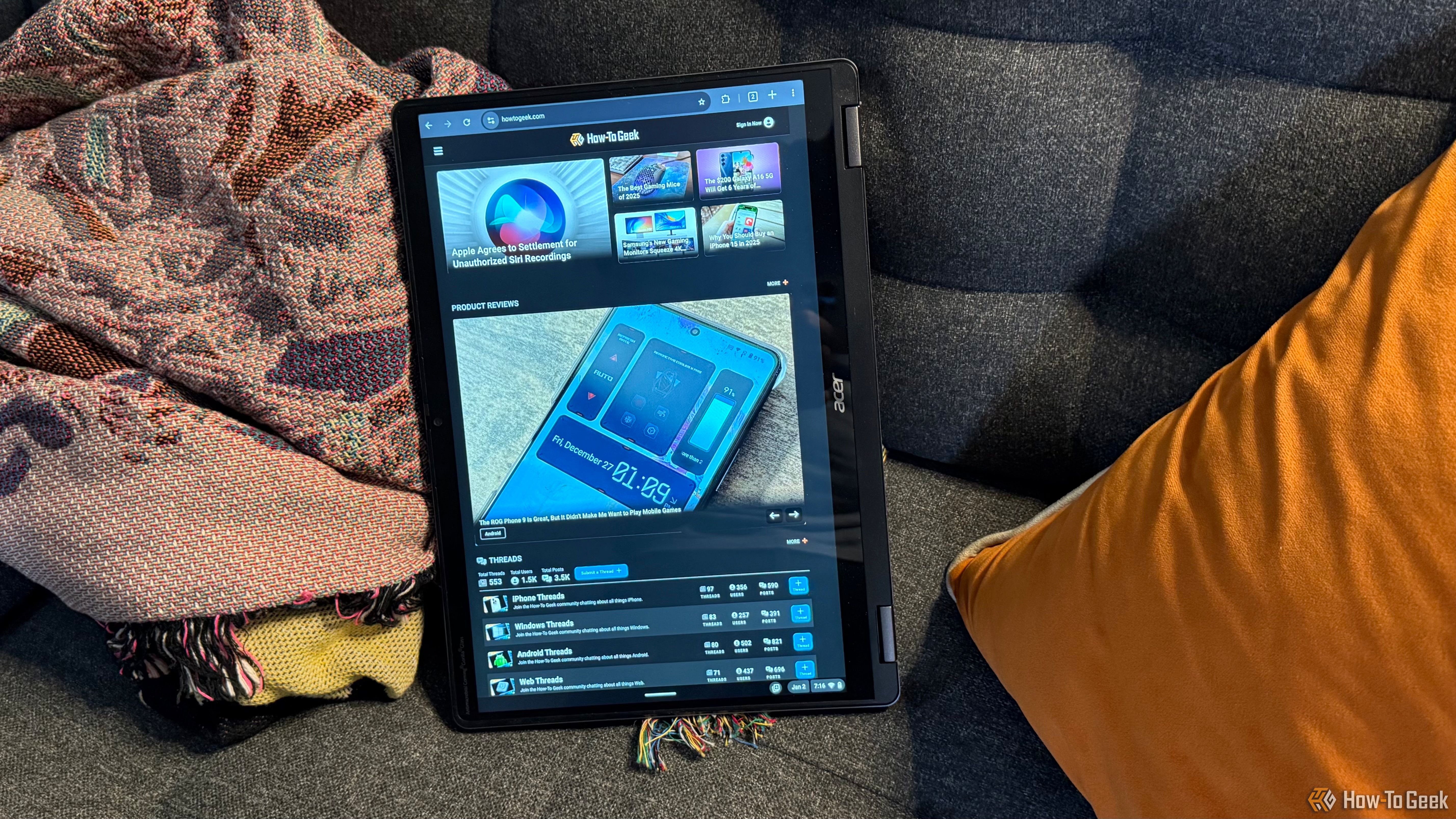 The Acer Chromebook Plus Spin 514 in tablet mode on a couch.