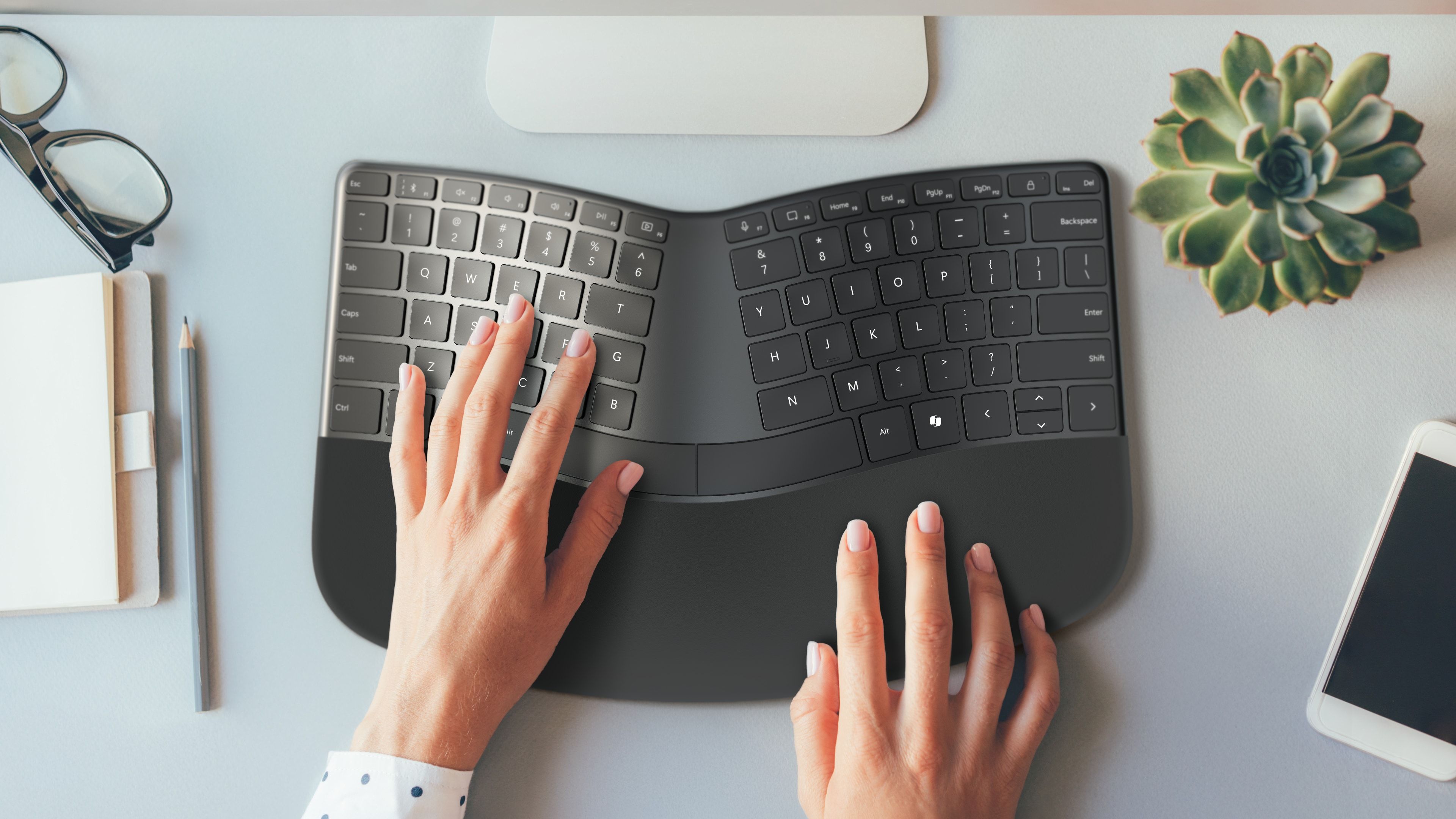 Top down view of hands typing on Incase's compact ergonomic keyboard.