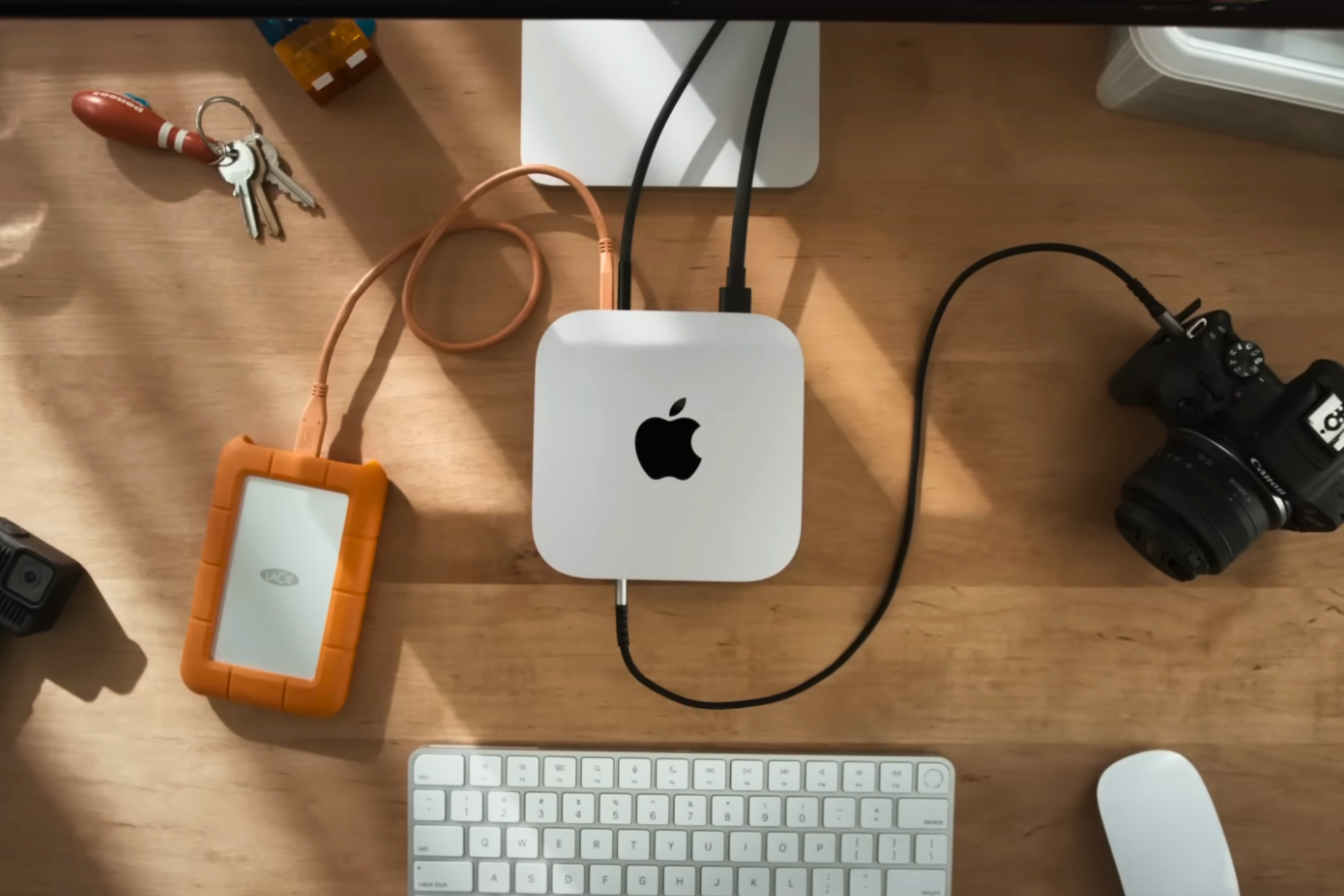 Top view of the M4 Mac mini on a desk with accessories around it.