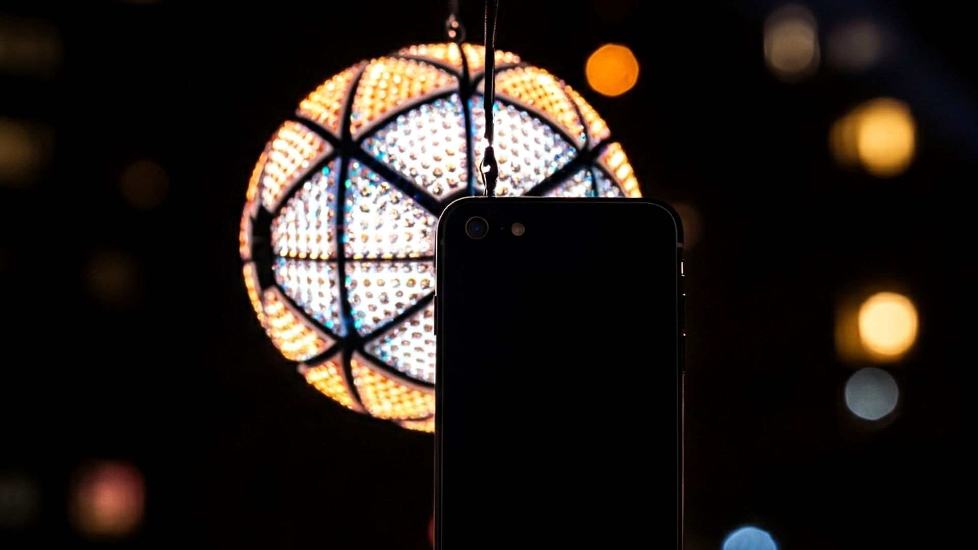 Phone held in front of NYE ball dropping.