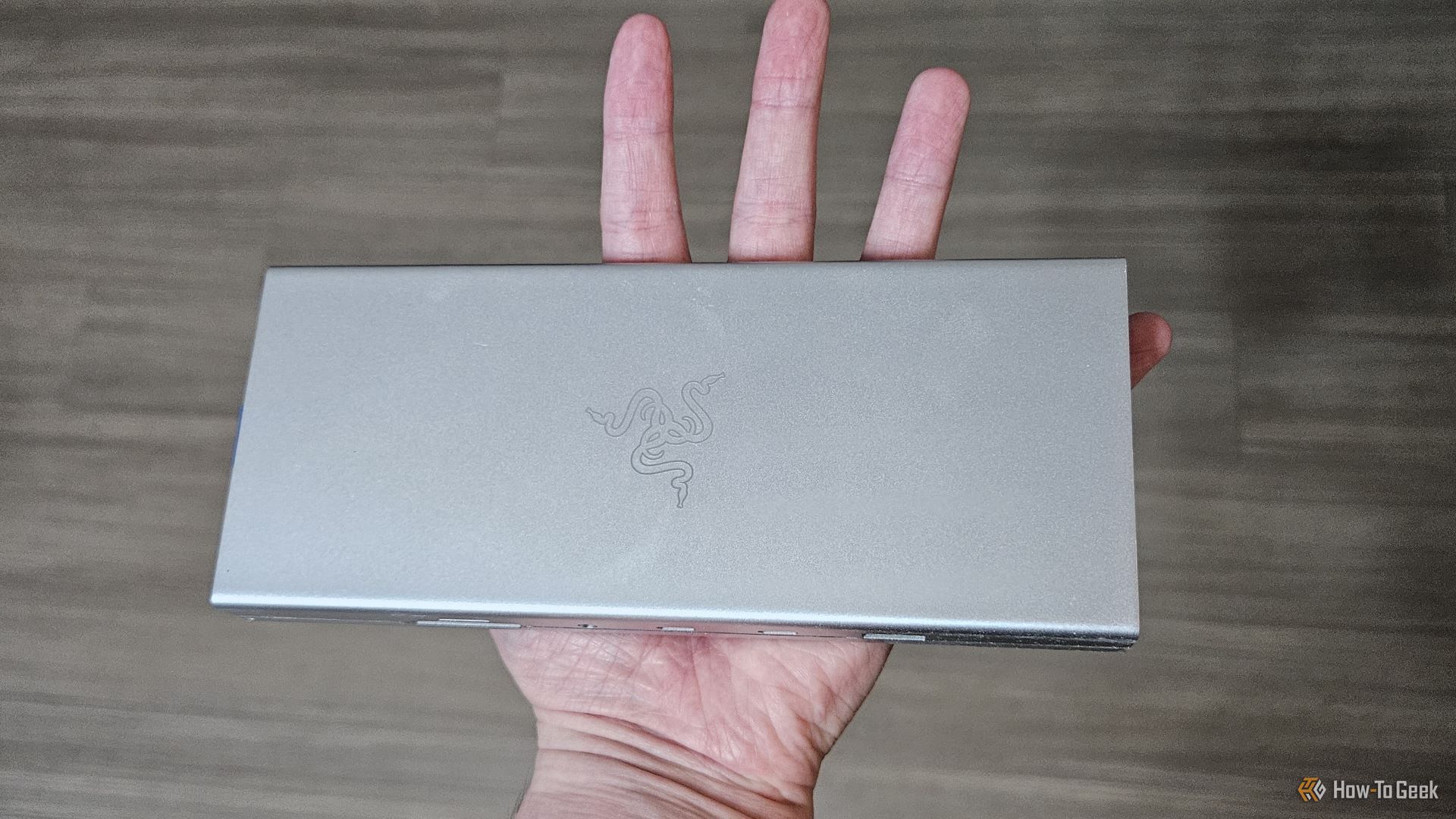 The Razer USB 4 Dock in someone's hand.