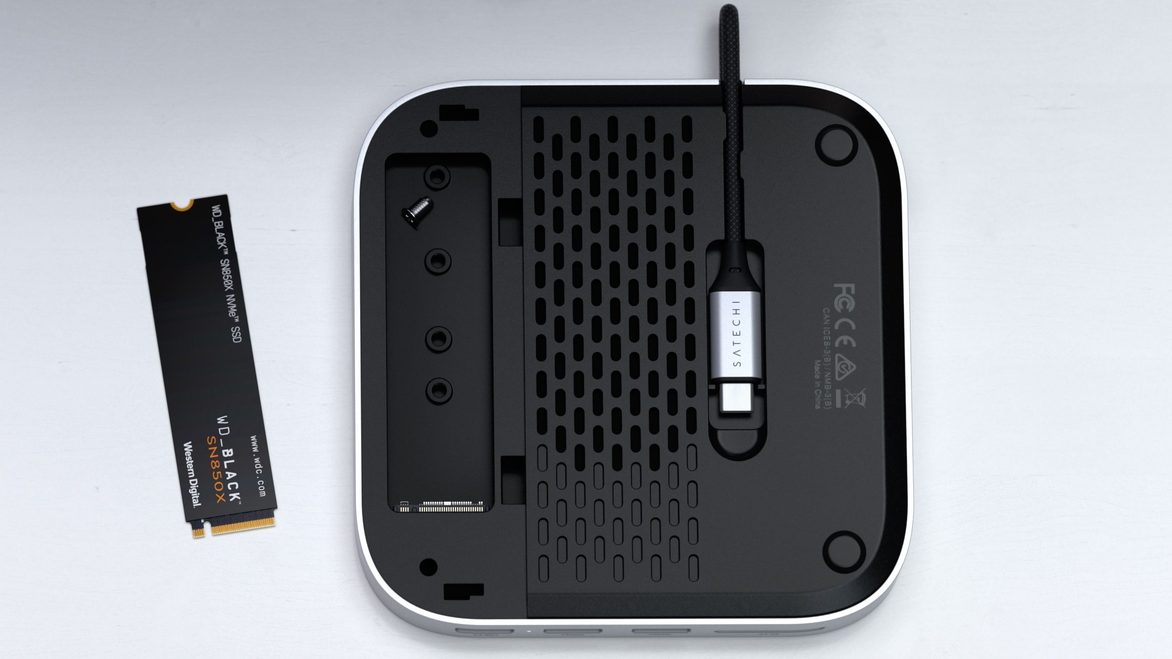 Satechi's Mac Mini hub laid flat, with an integrated NVMe enclosure on the back exposed.