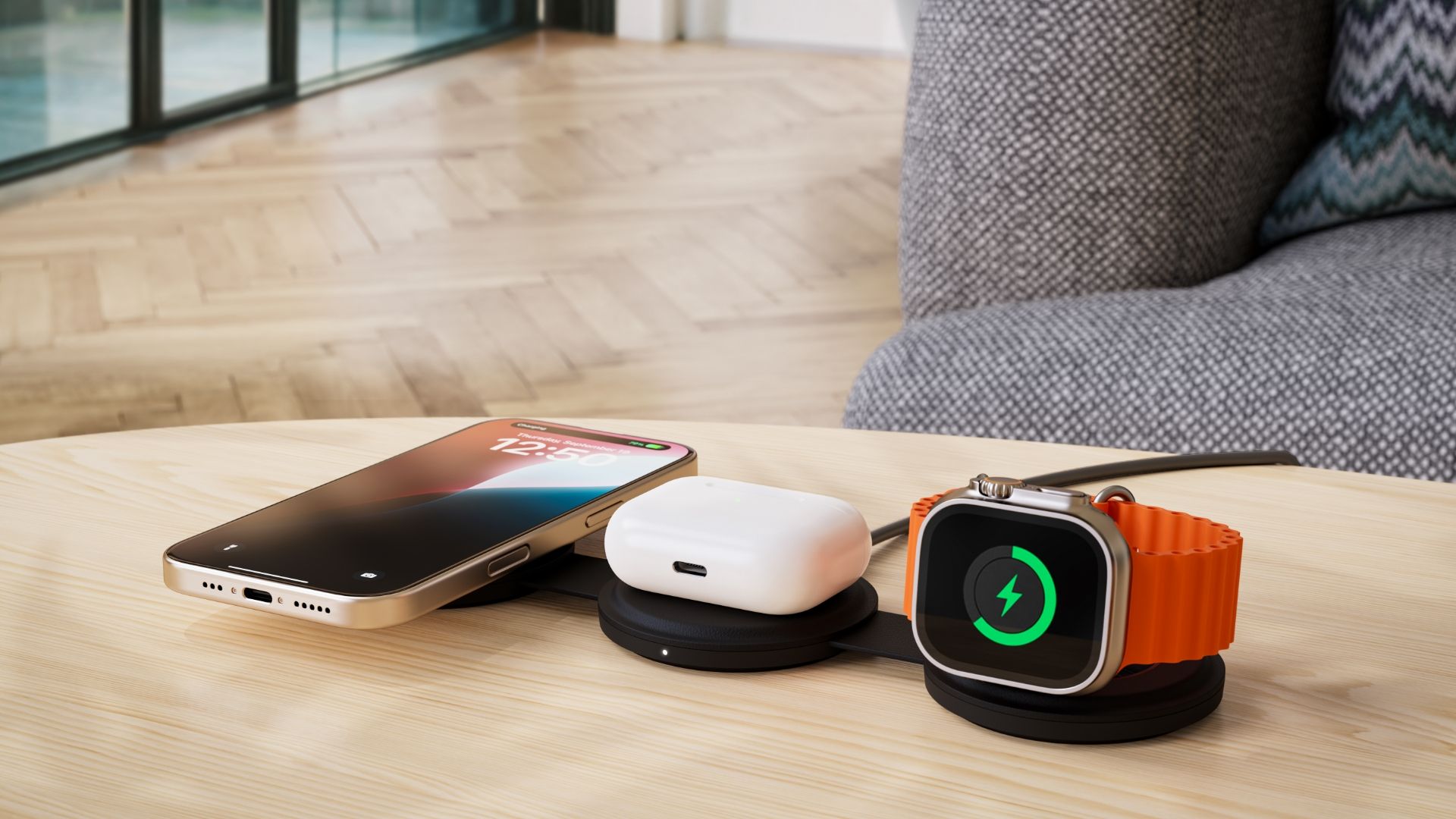 iPhone, AirPods, and Apple Watch on Satechi's wireless charger laying on a wooden desk.