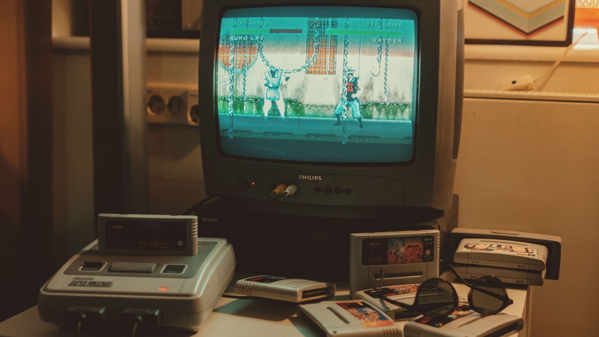 A Nintendo SNES hooked up to a CRT TV, surrounded by game cartridges.