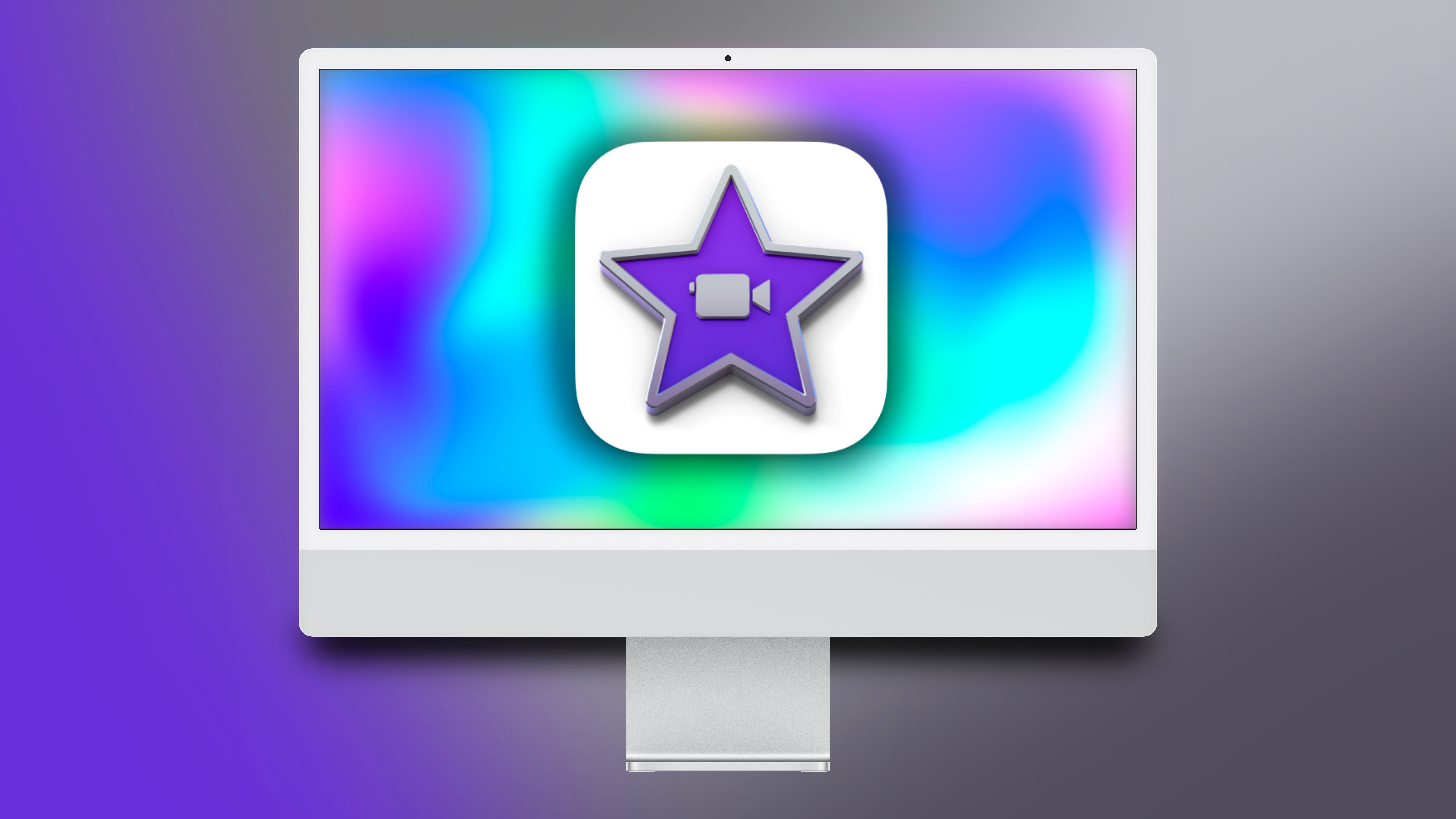 An iMac showcasing an iMovie icon on it in front of a colorful background.