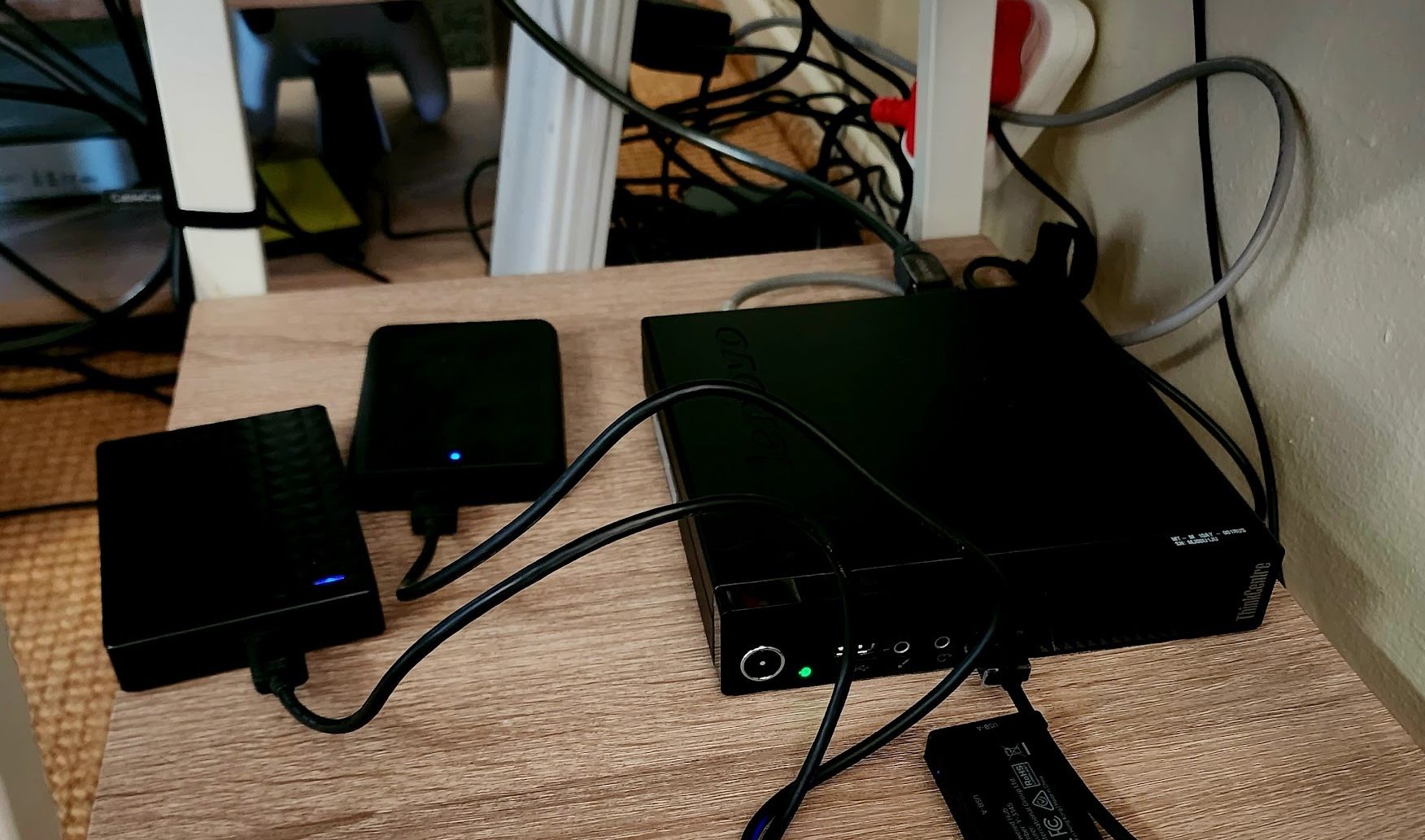 Mini PC Plex server with multiple USB drives connected.