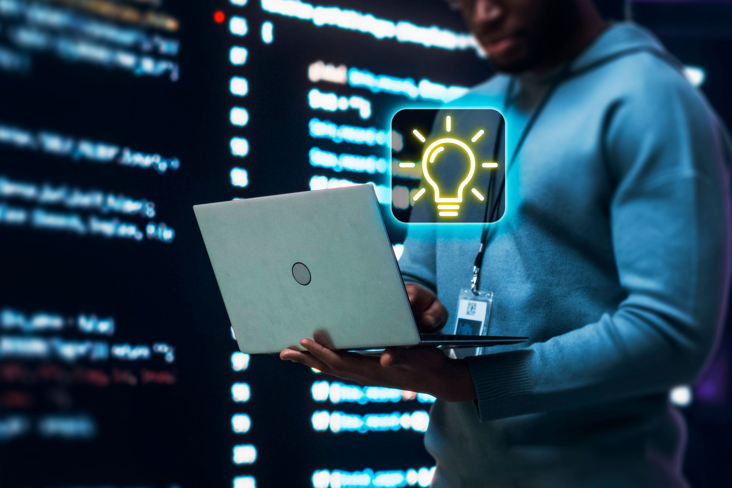 A man using a laptop with a tip symbol in the center