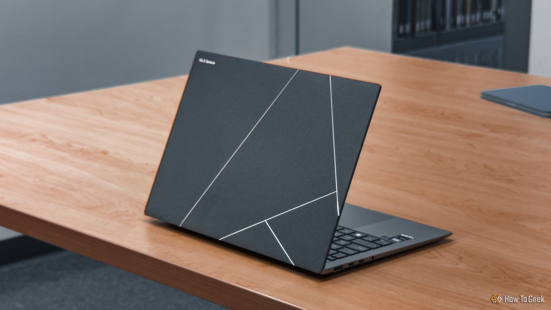 ASUS Zenbook S 14 angled on a wooden table.