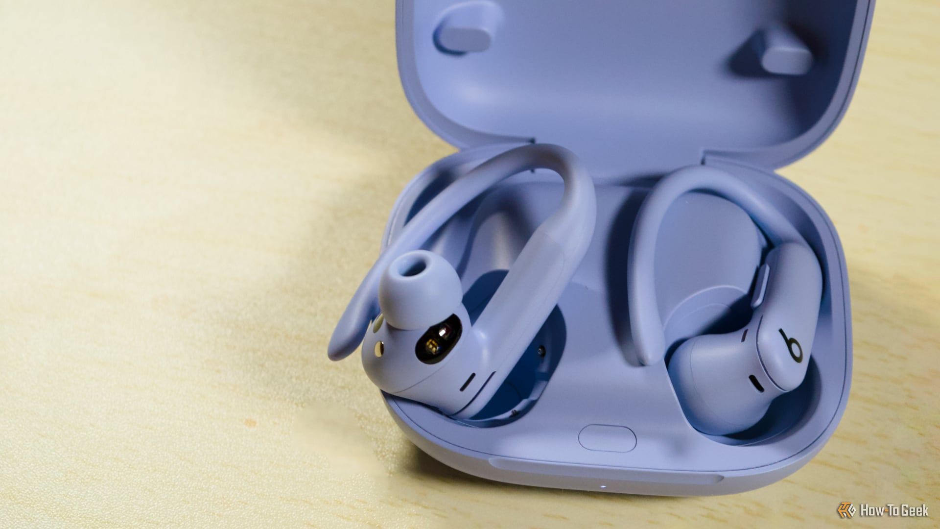 Beats PowerBeats Pro 2 sitting partially inside the case.