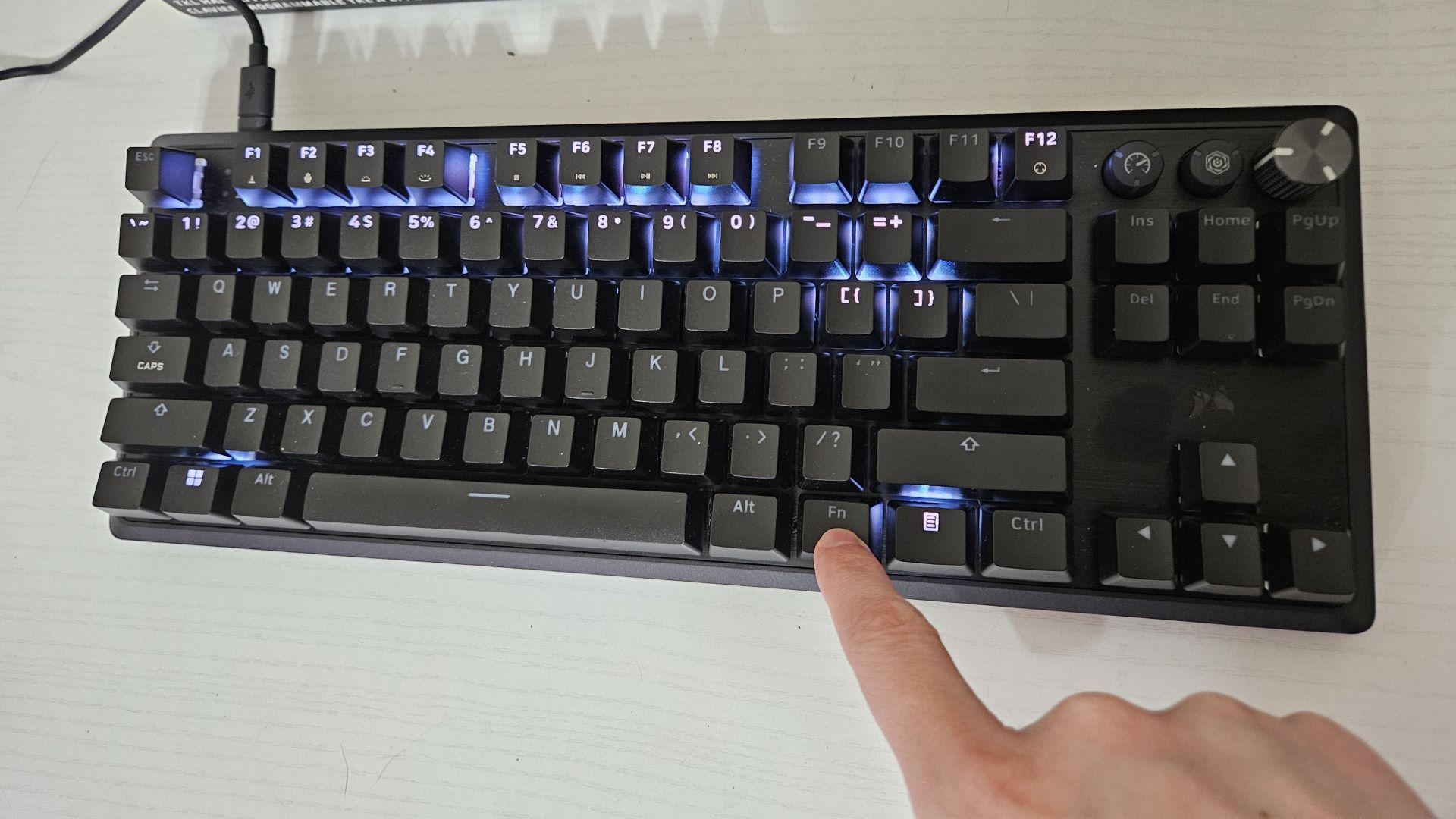 Someone pressing the FN Key on a Corsair K70 PRO TKL.